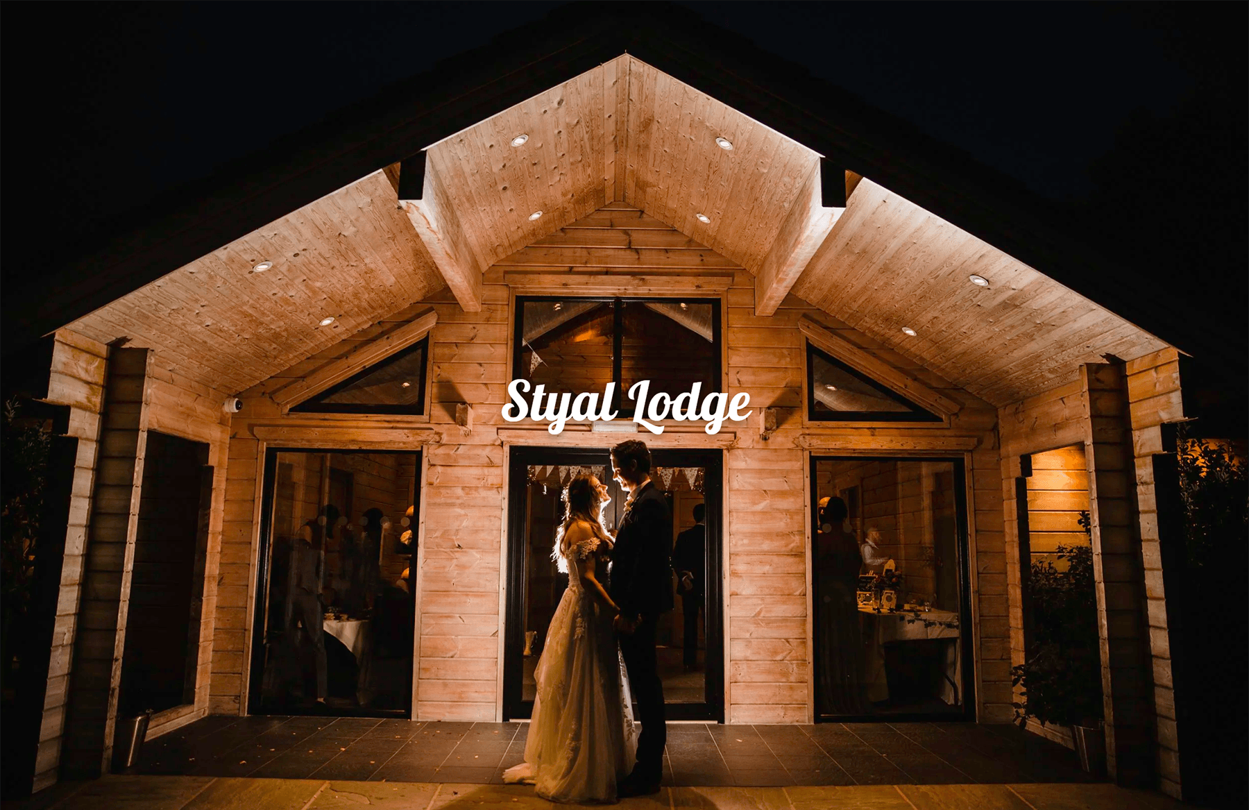 Styal Lodge wedding photography showcase link featuring nighttime lodge silhouette portrait