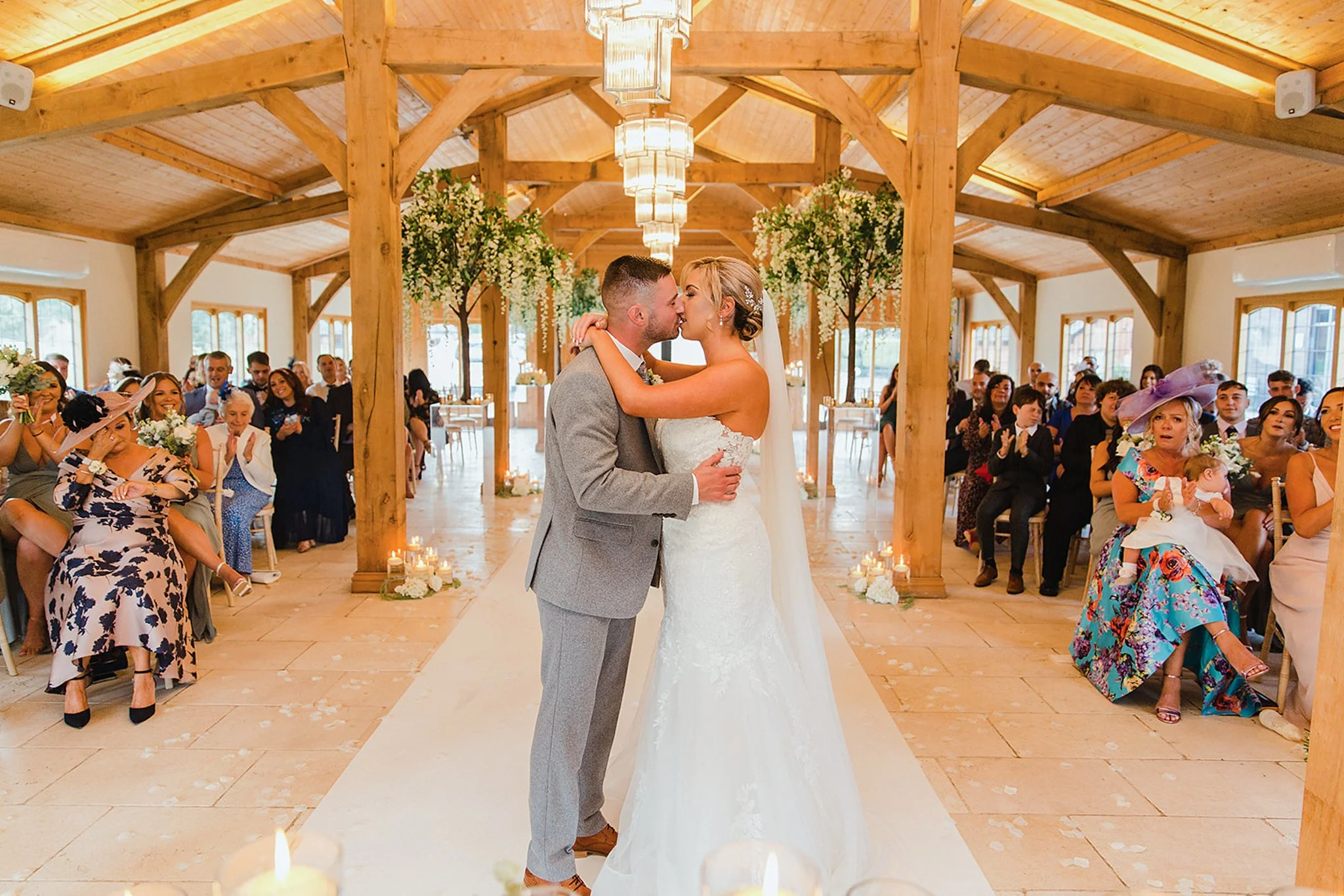 First kiss in the Stables Ceremony Room at Colshaw Hall during a relaxed spring wedding