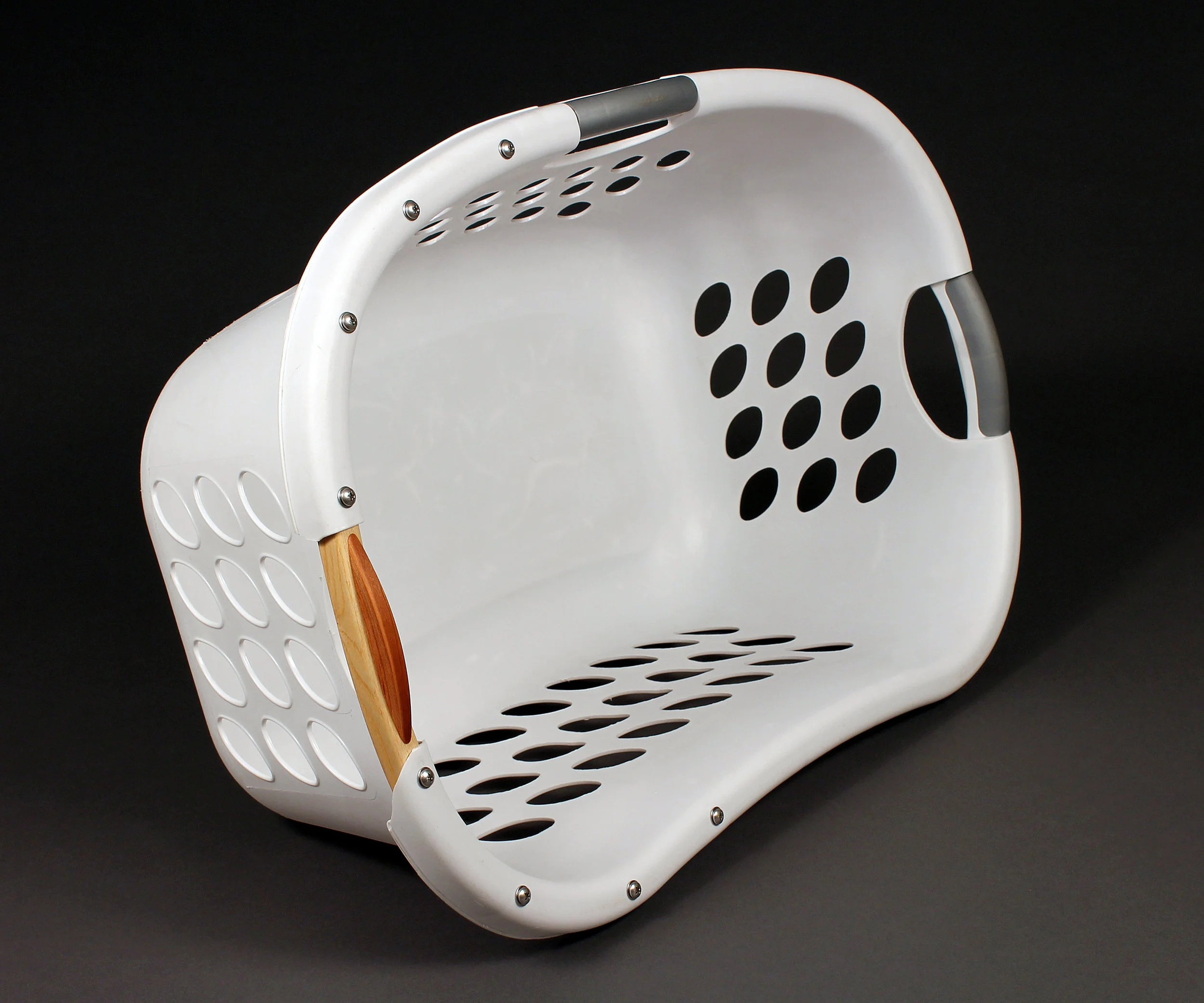 Making Amends No. 7 (Laura’s Laundry Basket) / Broken laundry basket, steam-bent ash, steam-bent cherry, hardware, C-print / 18” x 26” x 11”