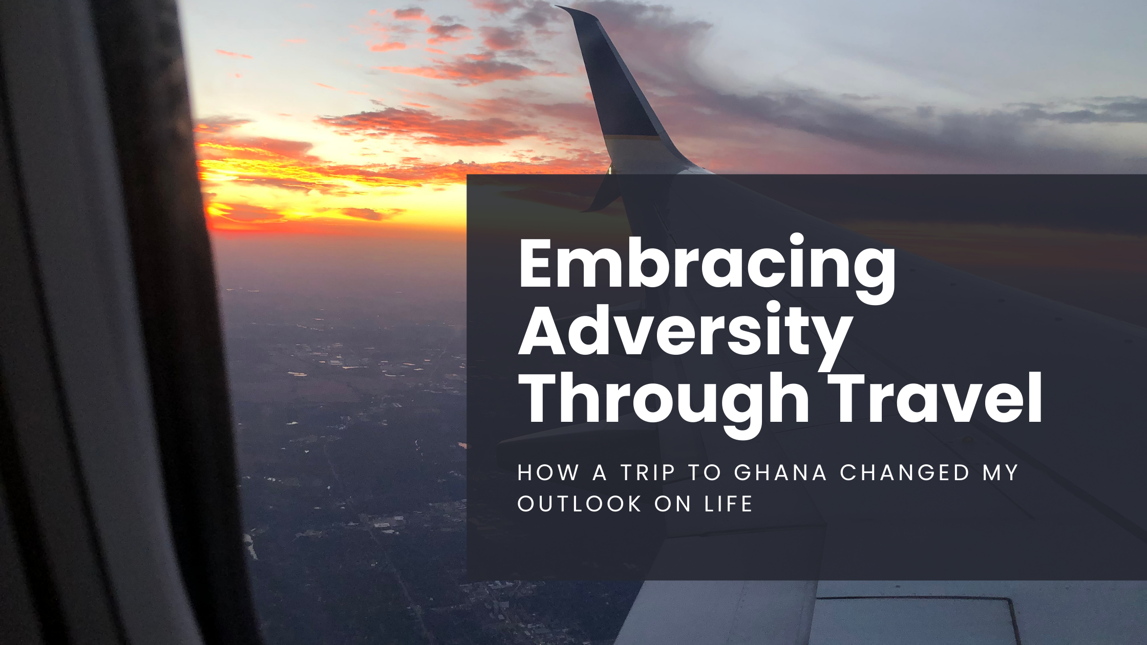The wing of an airplane as seen from the window seat of a plane with the sun setting in the background and lighting the sky orange and yellow