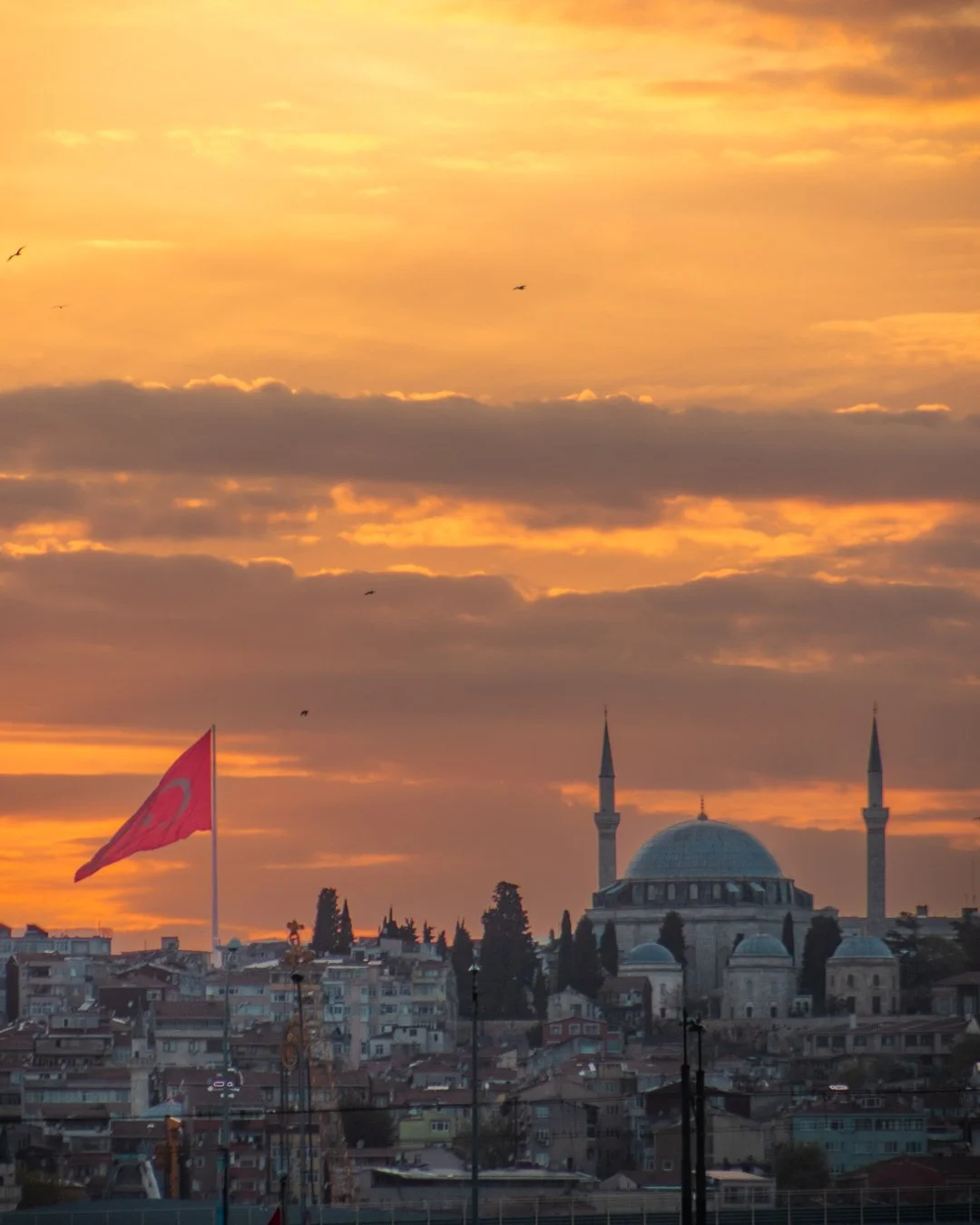 Sunset lights the sky over a mosque in Istanbul, Turkey