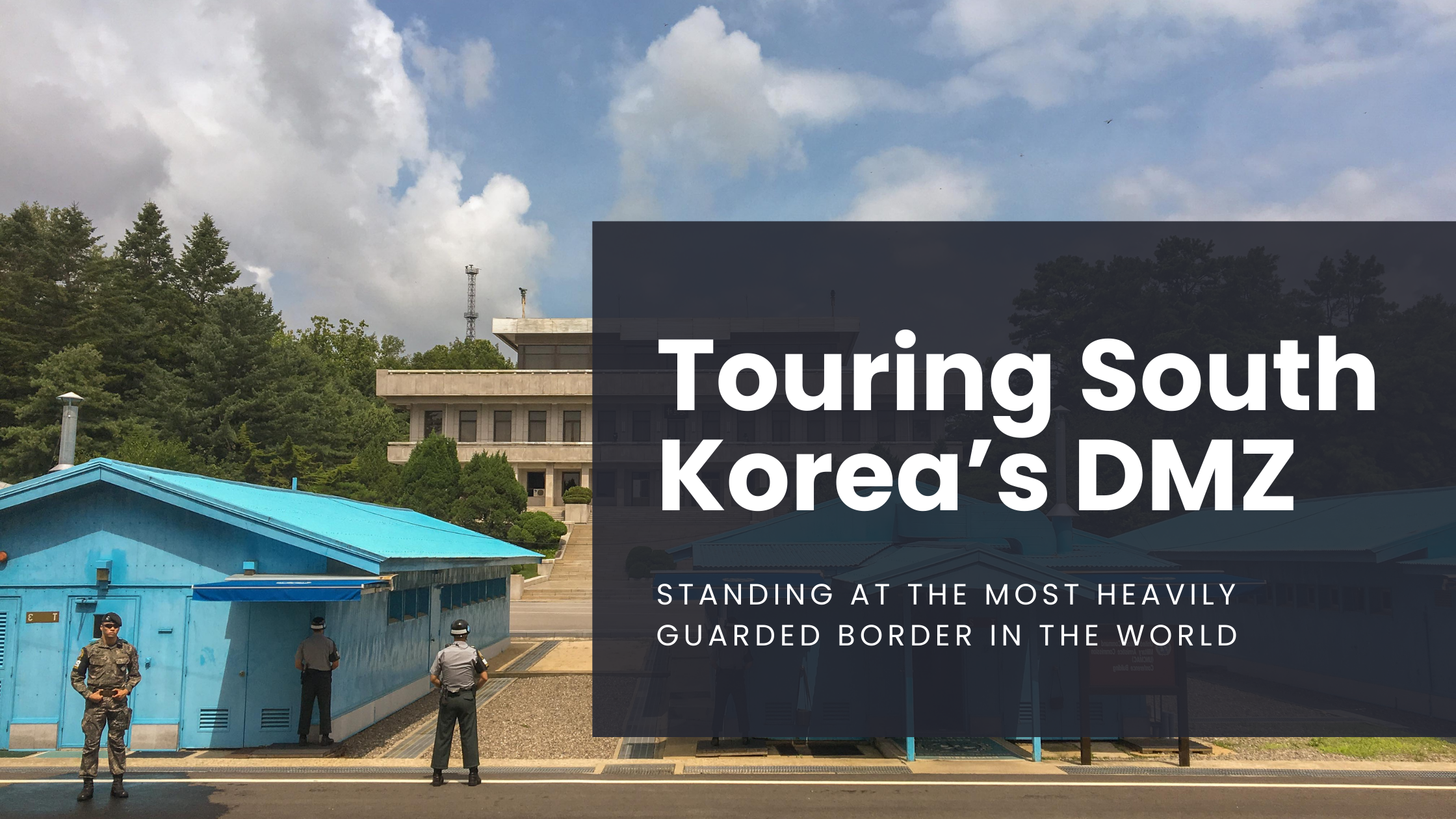 Military men stand outside of a blue UN house on the South Korean side of the DMZ, the border with North Korea