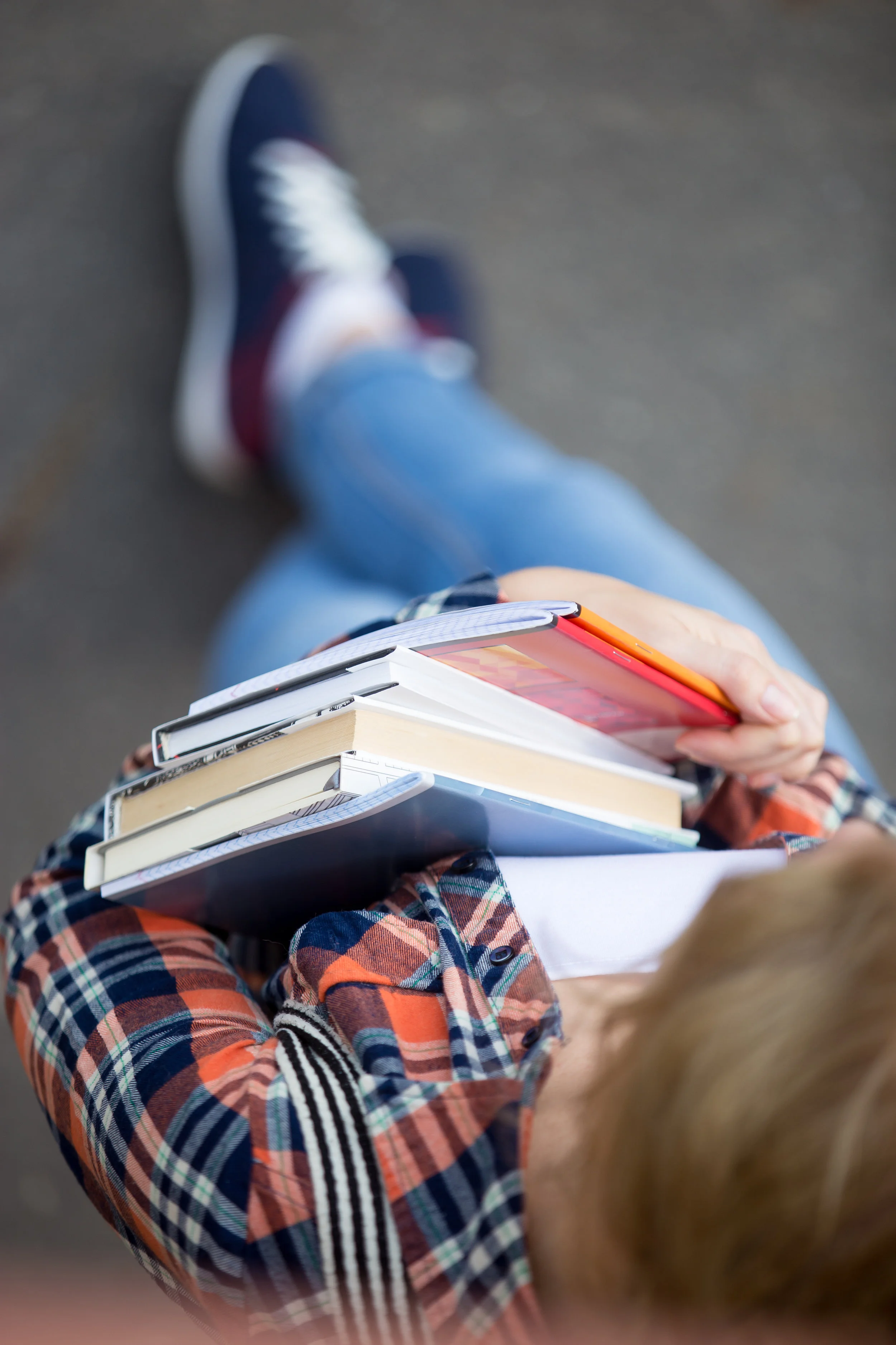 student-girl-with-a-heap-of-textbooks-and-PAWBBEW.jpg