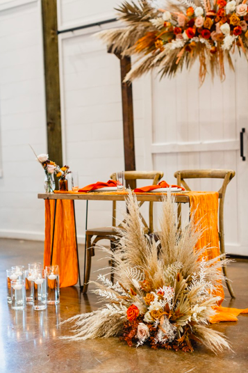  rentals pictured:  -nash - modern wood table $30.00  -floating vases (assorted heights) from $0.75  -burnt orange/rust cloth napkin $2.00  -terracotta table runner (assorted lengths available) from $2.00 