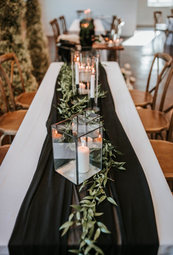  rentals pictured:  -white table cloths (various sizes/styles available) $11.00 each  -black iron glass hurricane (assorted sizes available) $7.00 each  -black metal trio candlestick holders $9.00 for set 
