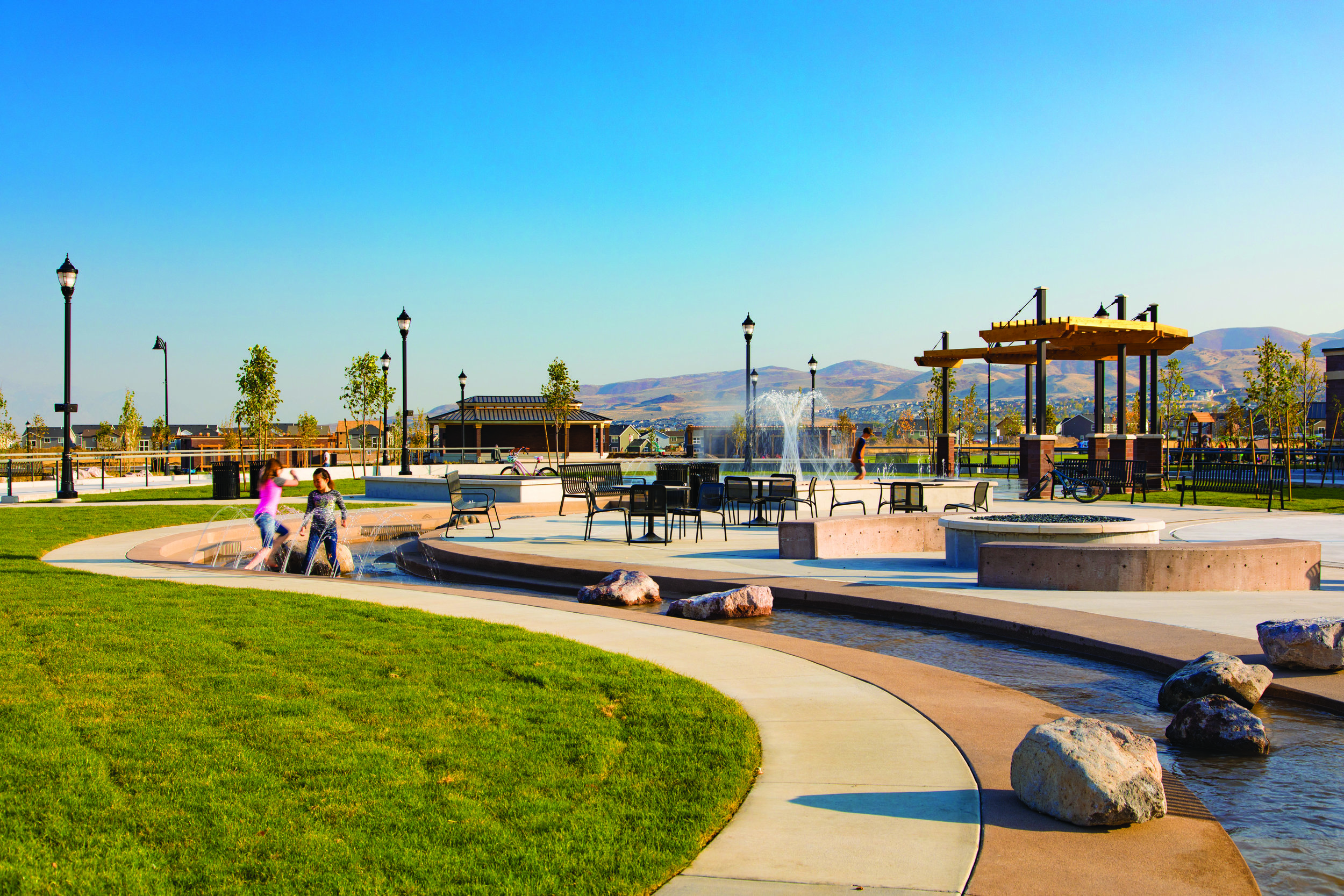  The middle section of the creek element is an interactive runnel water feature. The large fire ring of Fire and Ice Plaza is to the right of the stream. 