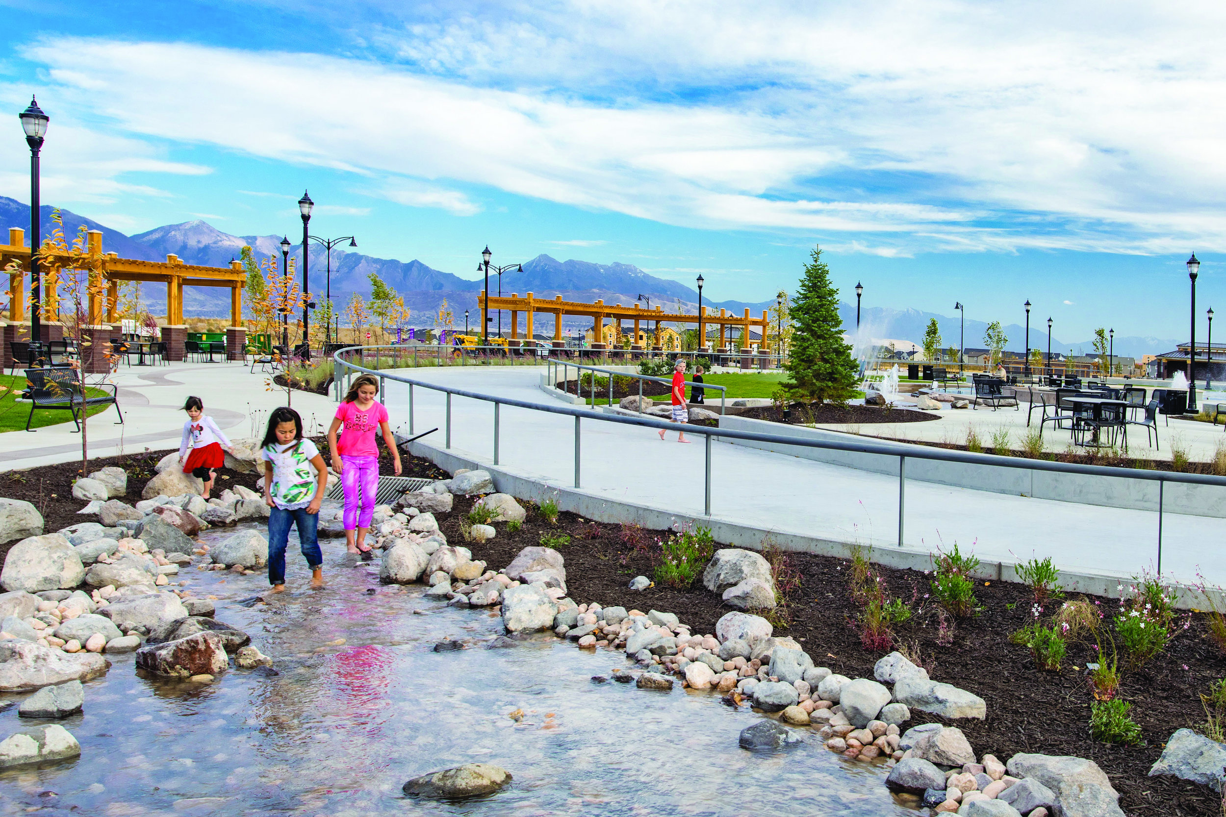  These children are enjoying the Natural Creek water feature segment of the implied meandering creek that runs through the Towne Center. 