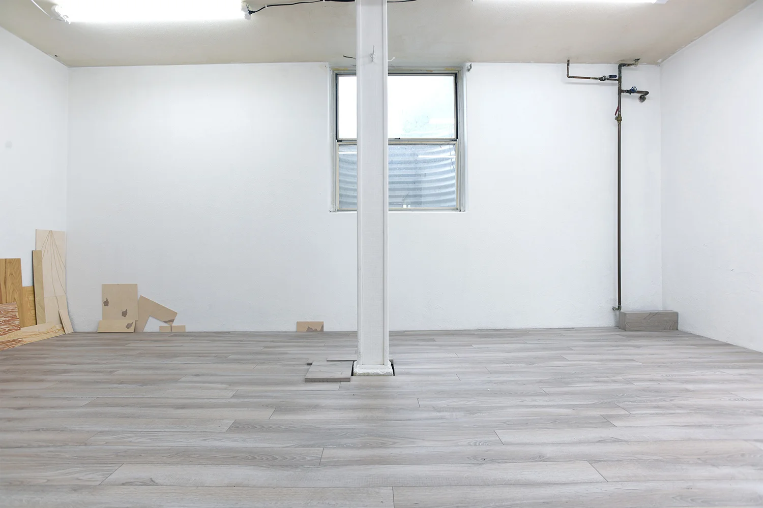 Masquetry V (detail), 2014–2018 Adhesive vinyl on found laminate and wood Floor Paintings , 2018 Acrylic on MDF on floor
