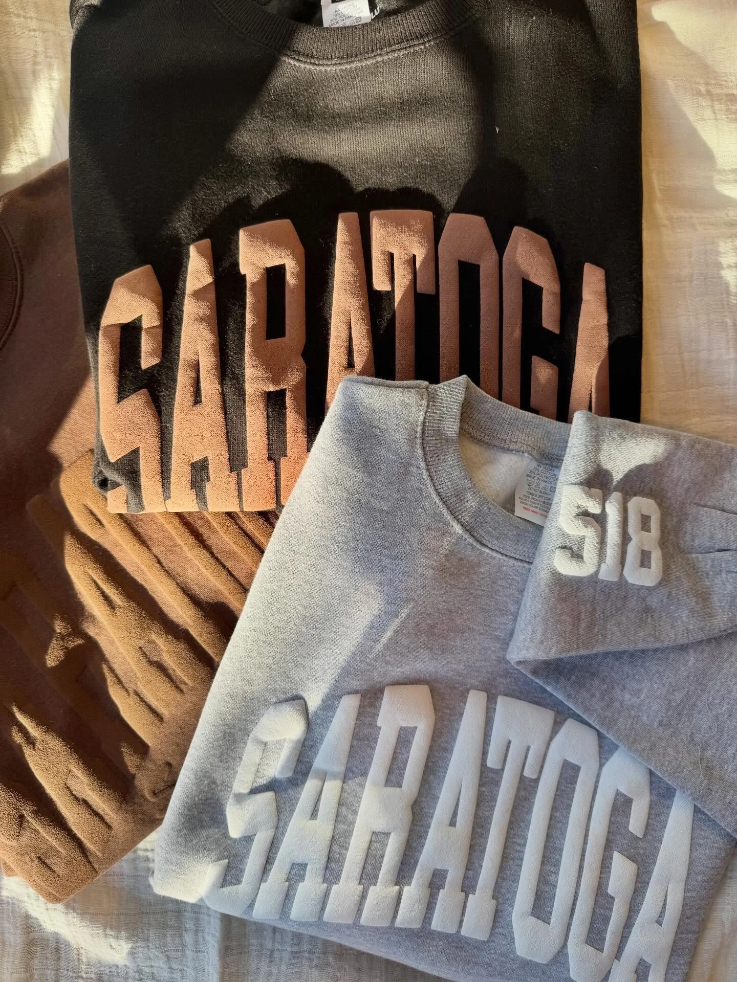 We&rsquo;re stocked up on everyone&rsquo;s favorite Saratoga crewnecks 🤍 come grab one to stay warm during Chowder Fest this Saturday ❄️🧣
&bull;
&bull;
&bull;
#crewnecks #saratoga #cozy #chowderfest #shopsmall