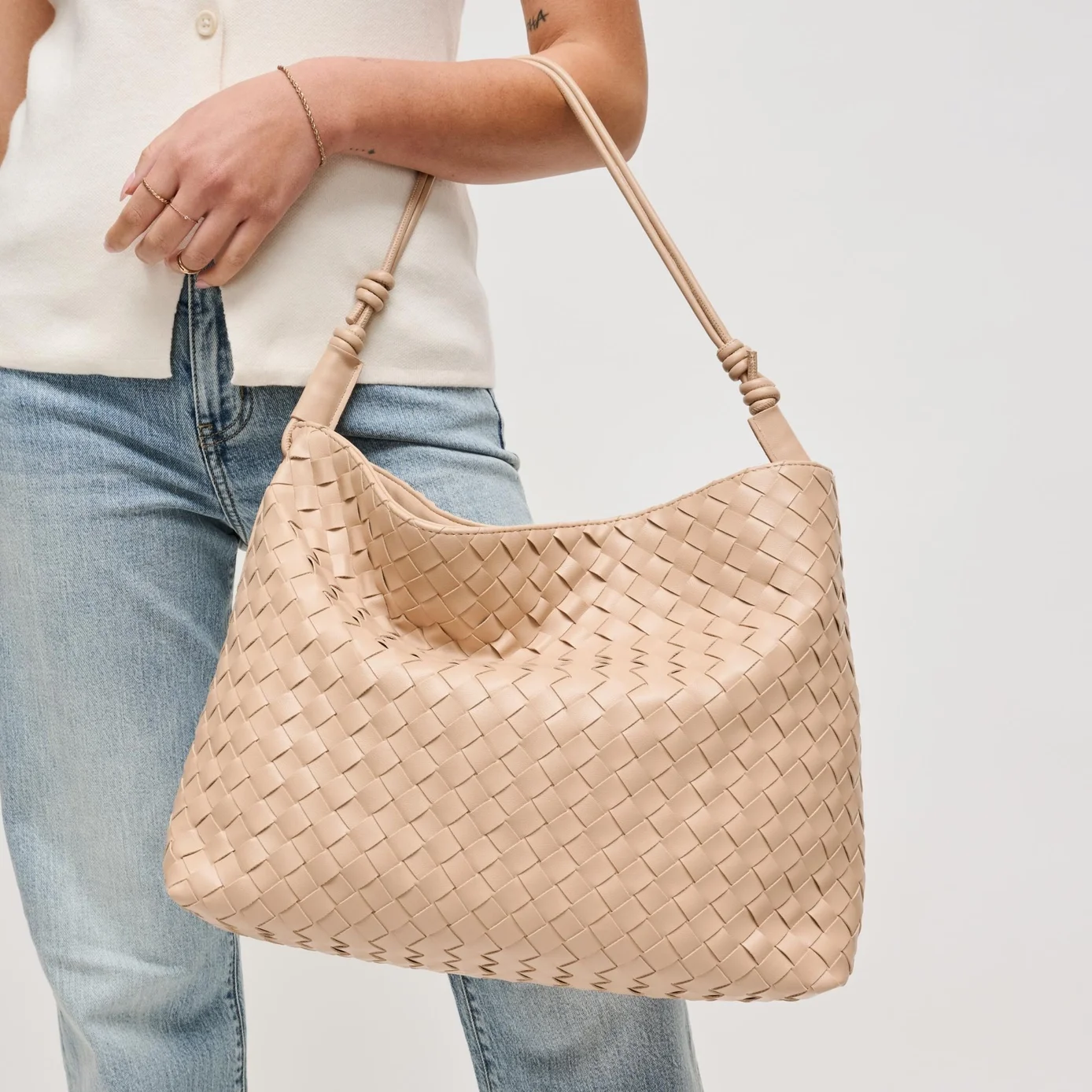 Theo woven hobo bag in almond, shown on a model