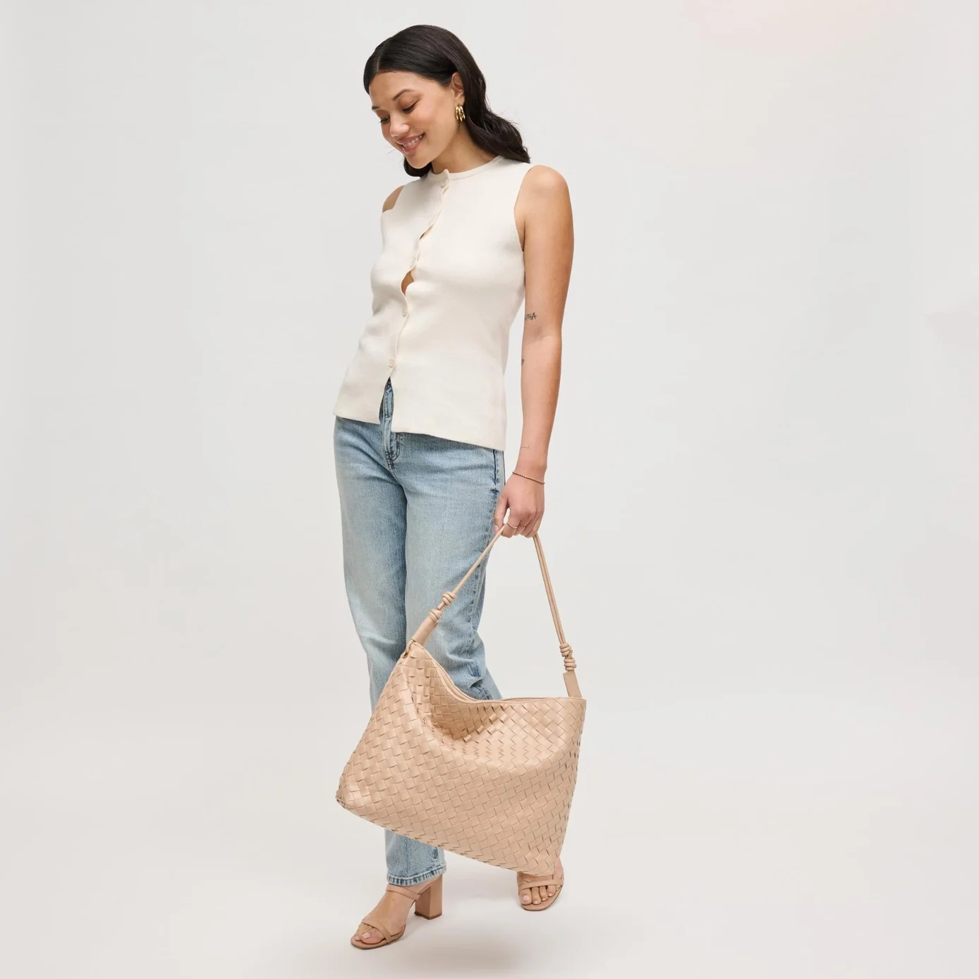 Theo woven hobo bag in almond, shown on a model