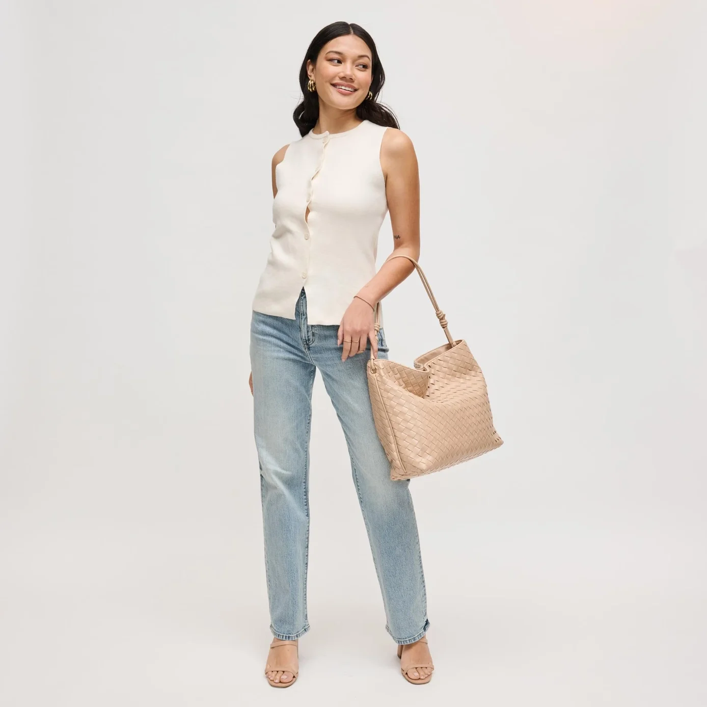 Theo woven hobo bag in almond, shown on a model