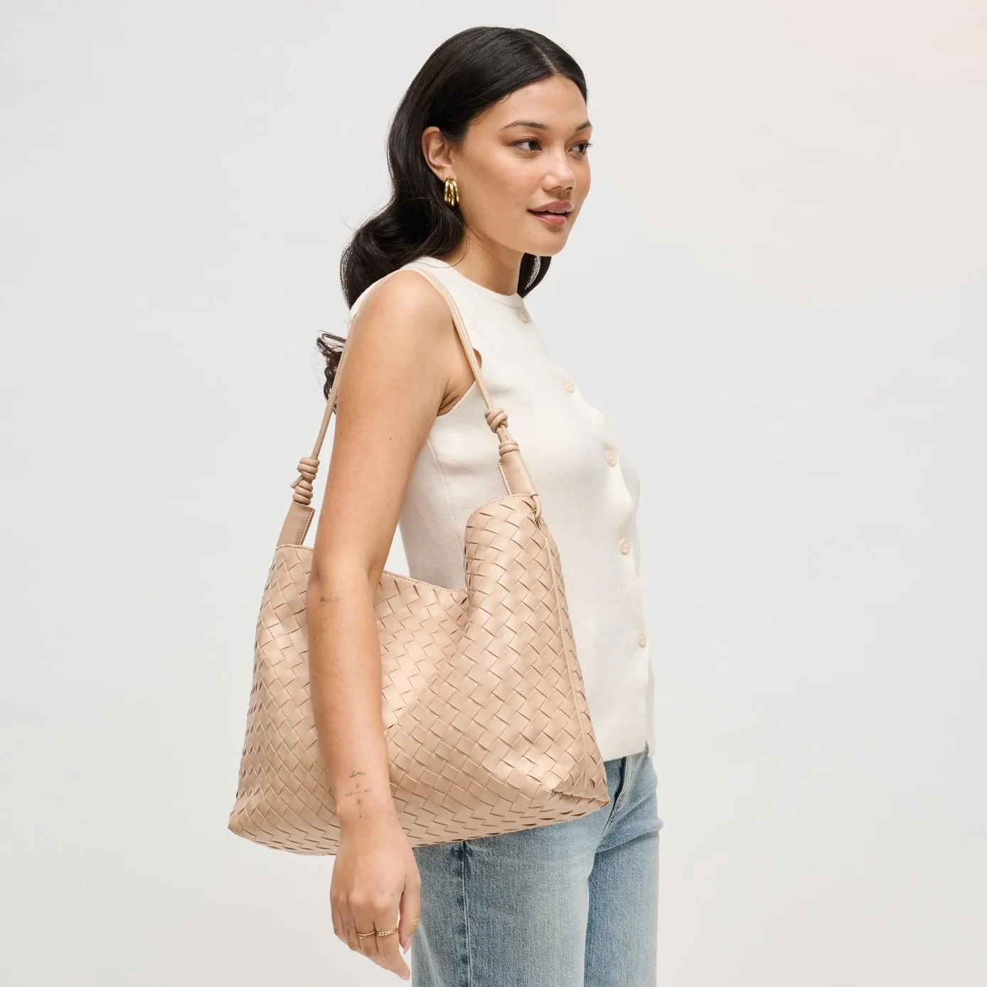 Theo woven hobo bag in almond, shown on a model