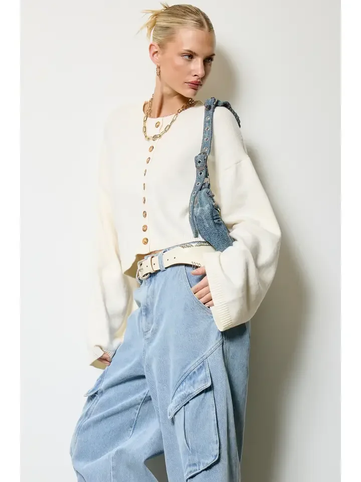 Button front cropped cardigan in bone worn with baggy jeans