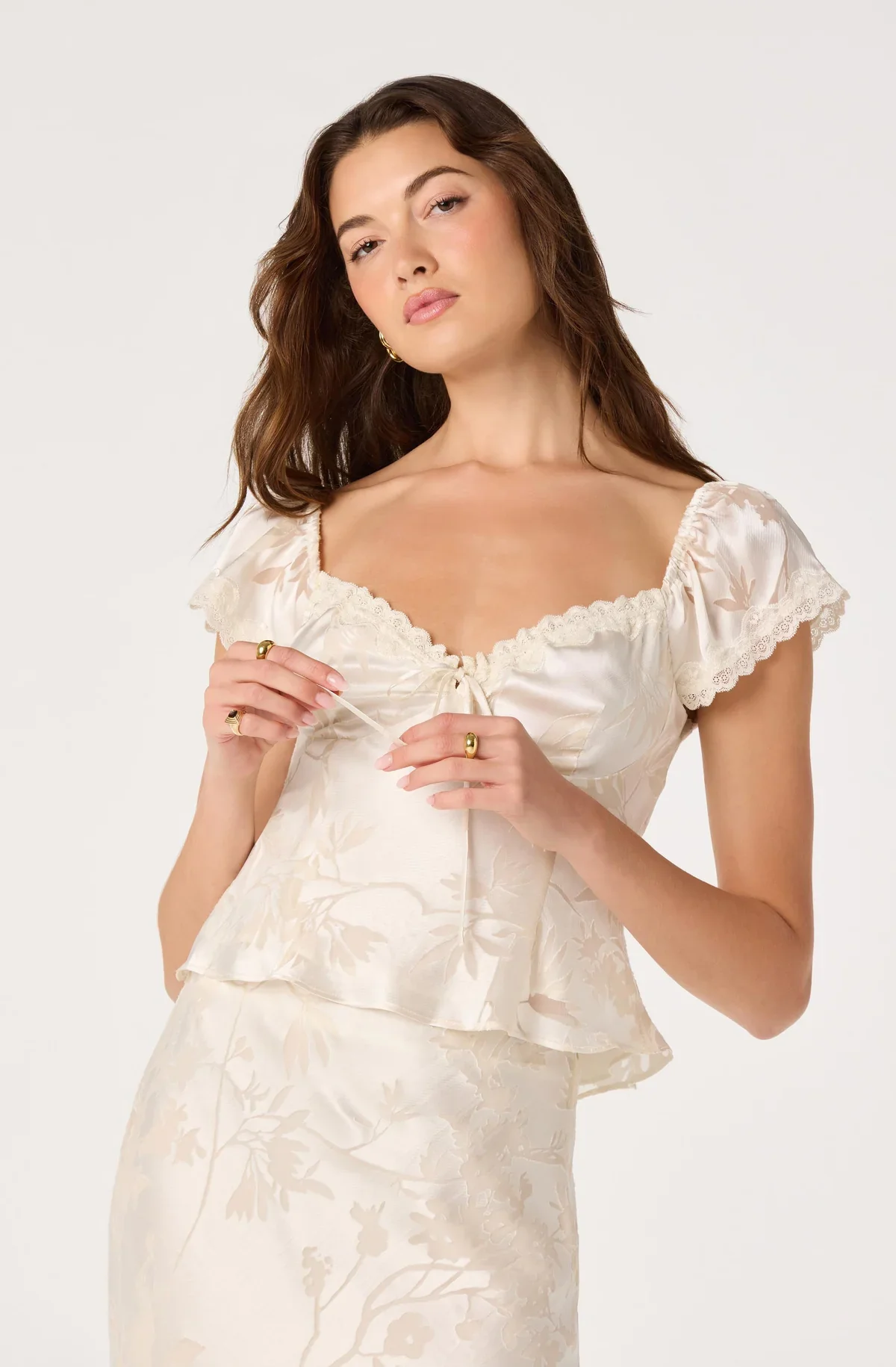 Close-up of the Vanessa cream top's sweetheart neckline and cap sleeves
