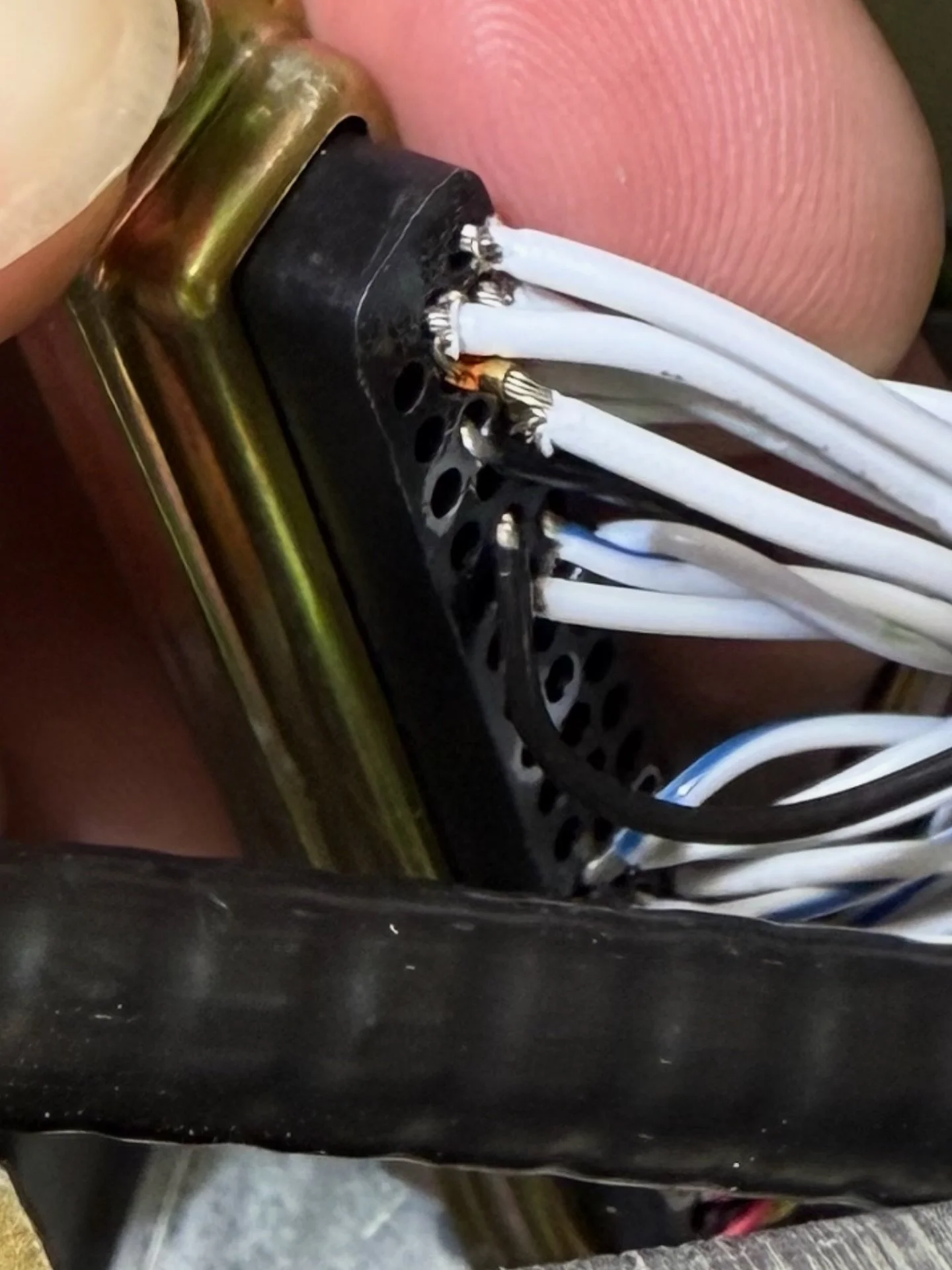 This is how you cause a direct short and a fire. You can see some melting of the connector where it was already arcing. When this transponder was installed, they cut the conductor strands of the 18ga power and ground wires to get it to fit into a hig