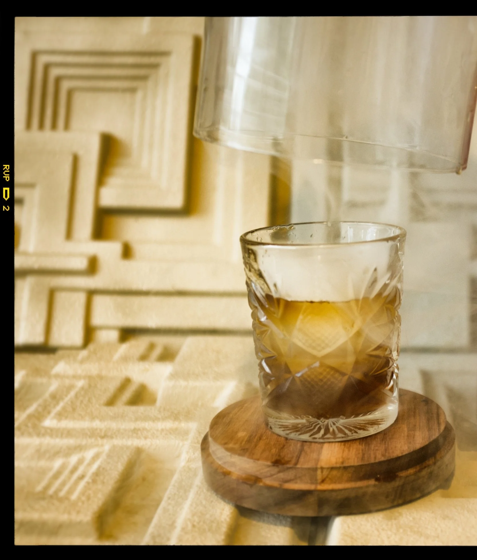 NEOTROPOLIS OLD FASHIONED. Our signature Old Fashioned- blended whisky infused with chrysanthemum and chamomile tea, house-made Guinness bitter syrup, black lemon bitters, and mesquite smoke.