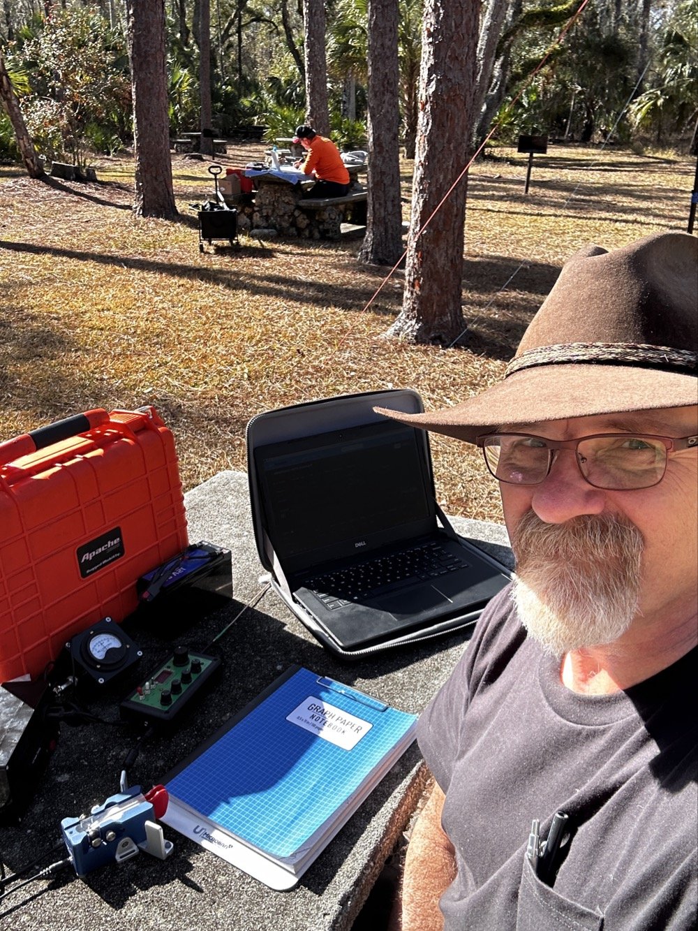 WK4DS David Saylors operating POTA activation with multi-operator setup visible in background at Hillsborough River State Park