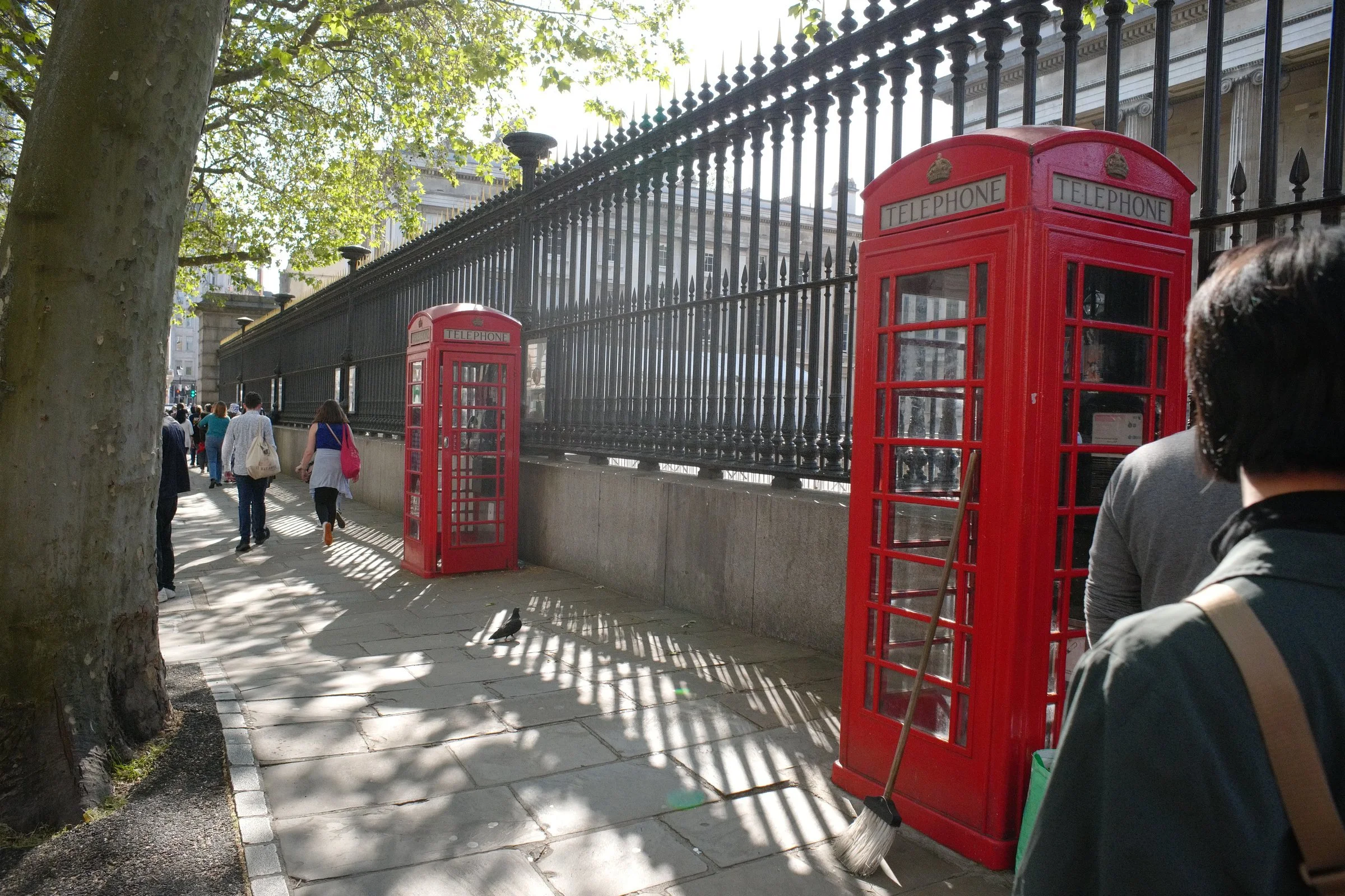 The fence outside the British Museum showcasing the iconic telephone booths in London.