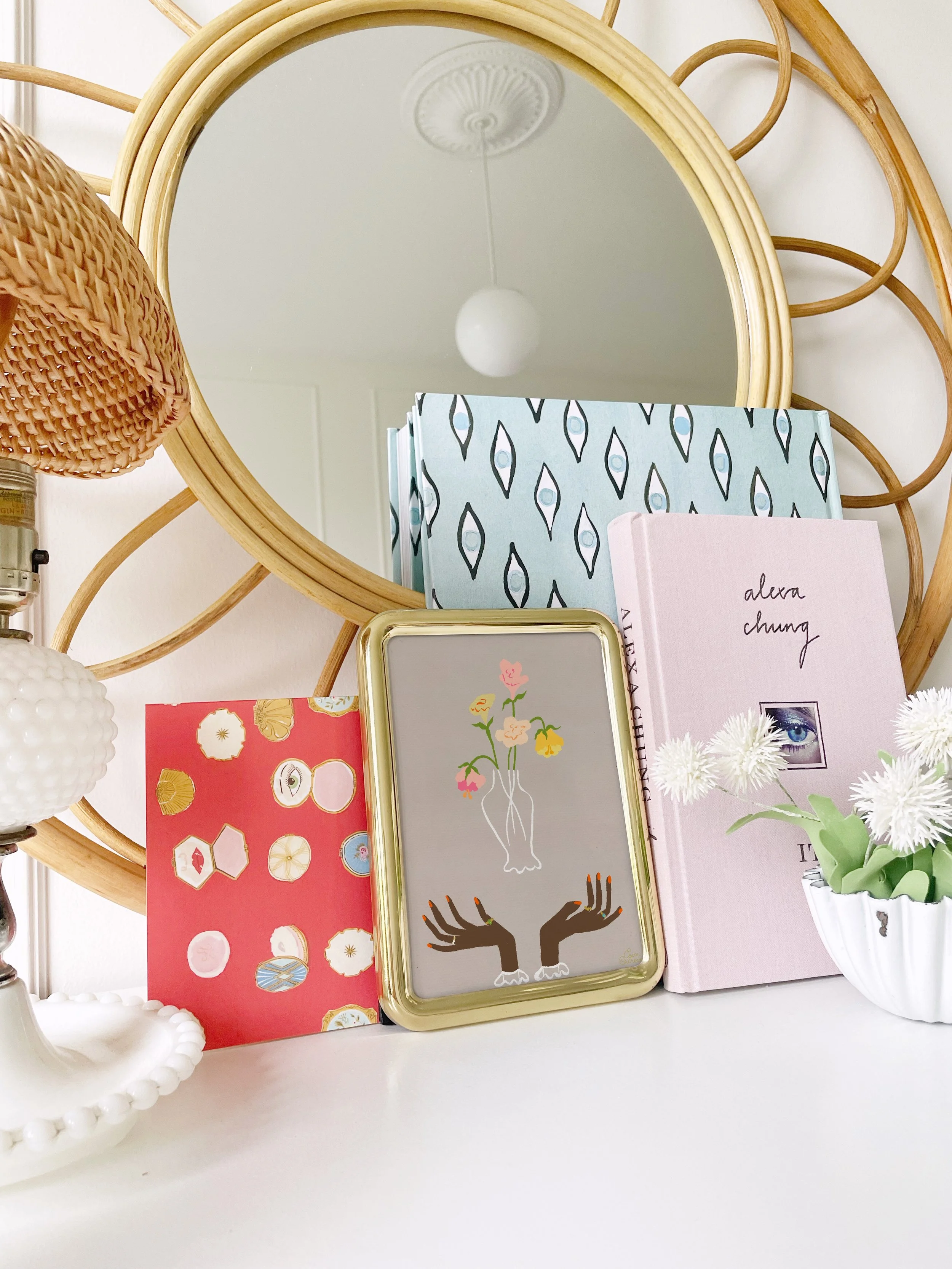 “Floral Arrangement” whimsical wall art by Erica Catherine, displayed in a styled interior. Features a vase of roses and soft romantic details.