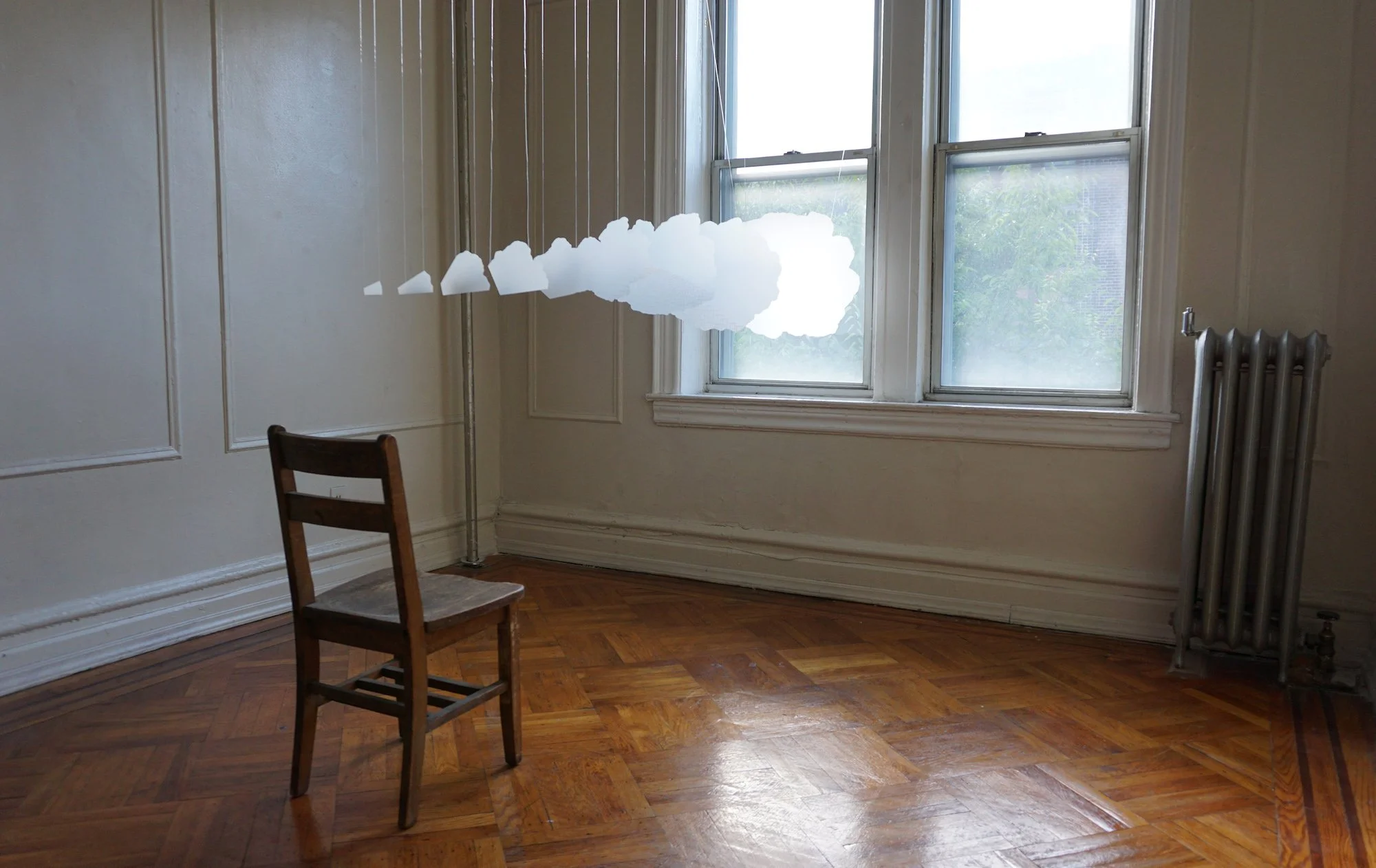 Opening, installation, dimensions variable, materials: drafting paper, elastic cord, glue, white pencil, chair, 2022
