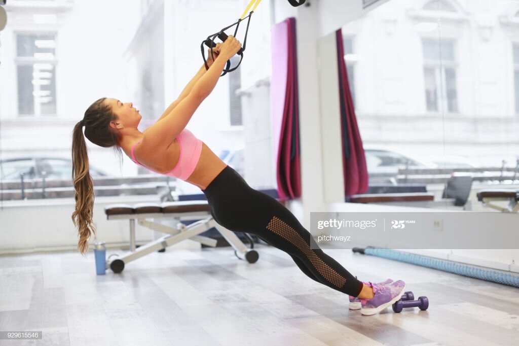 Woman doing posture correcting back exercise at the gym