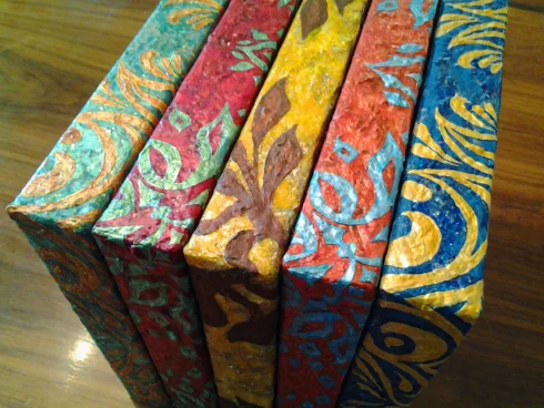Colorful artworks in boards with wooden background