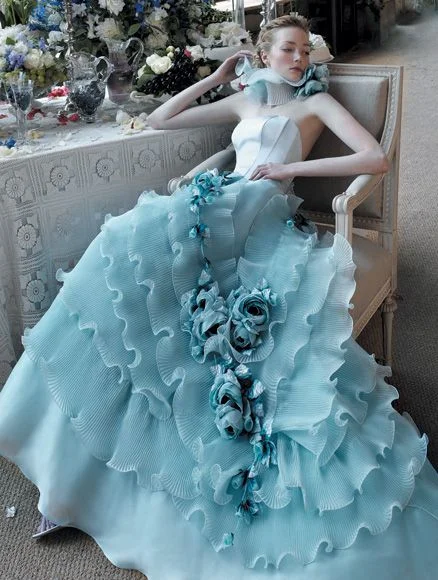 Beautiful woman sitting on wooden armchair wearing a blue wedding dress
