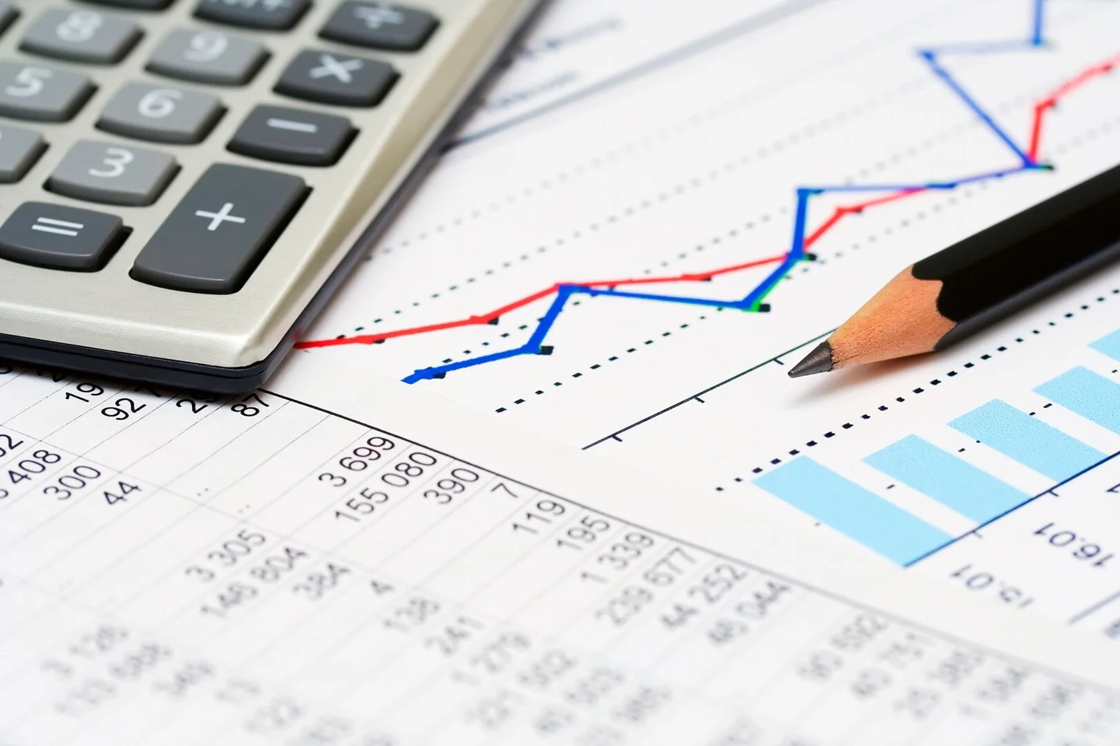 calculator and pencil and numbers and charts