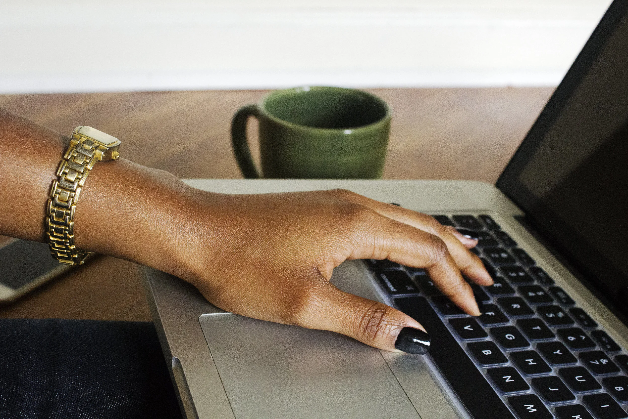 black-woman-hand-on-laptop-createherstock.jpg