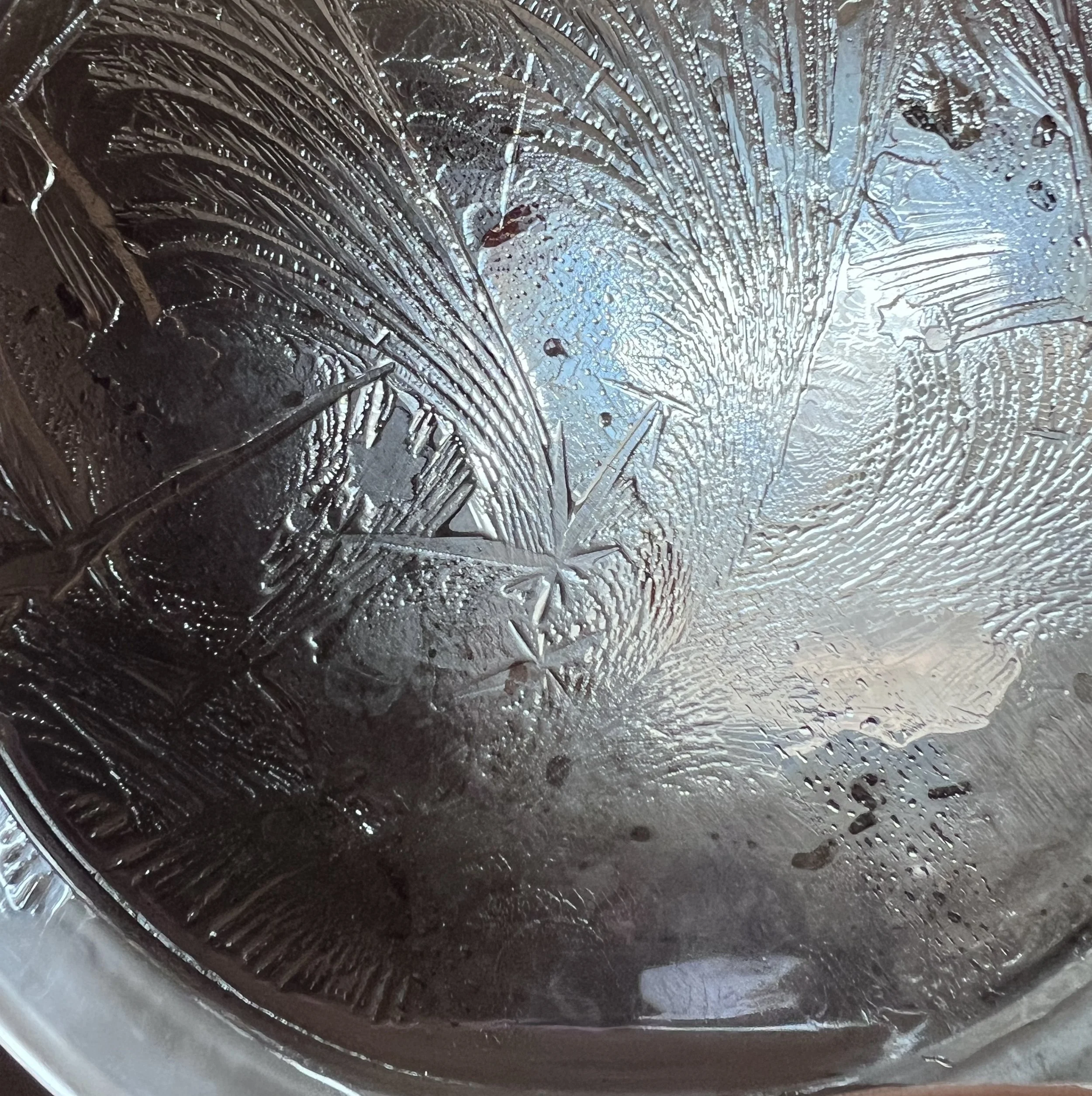 Close-up of a petri-dish with ice patterns and hydroglyph