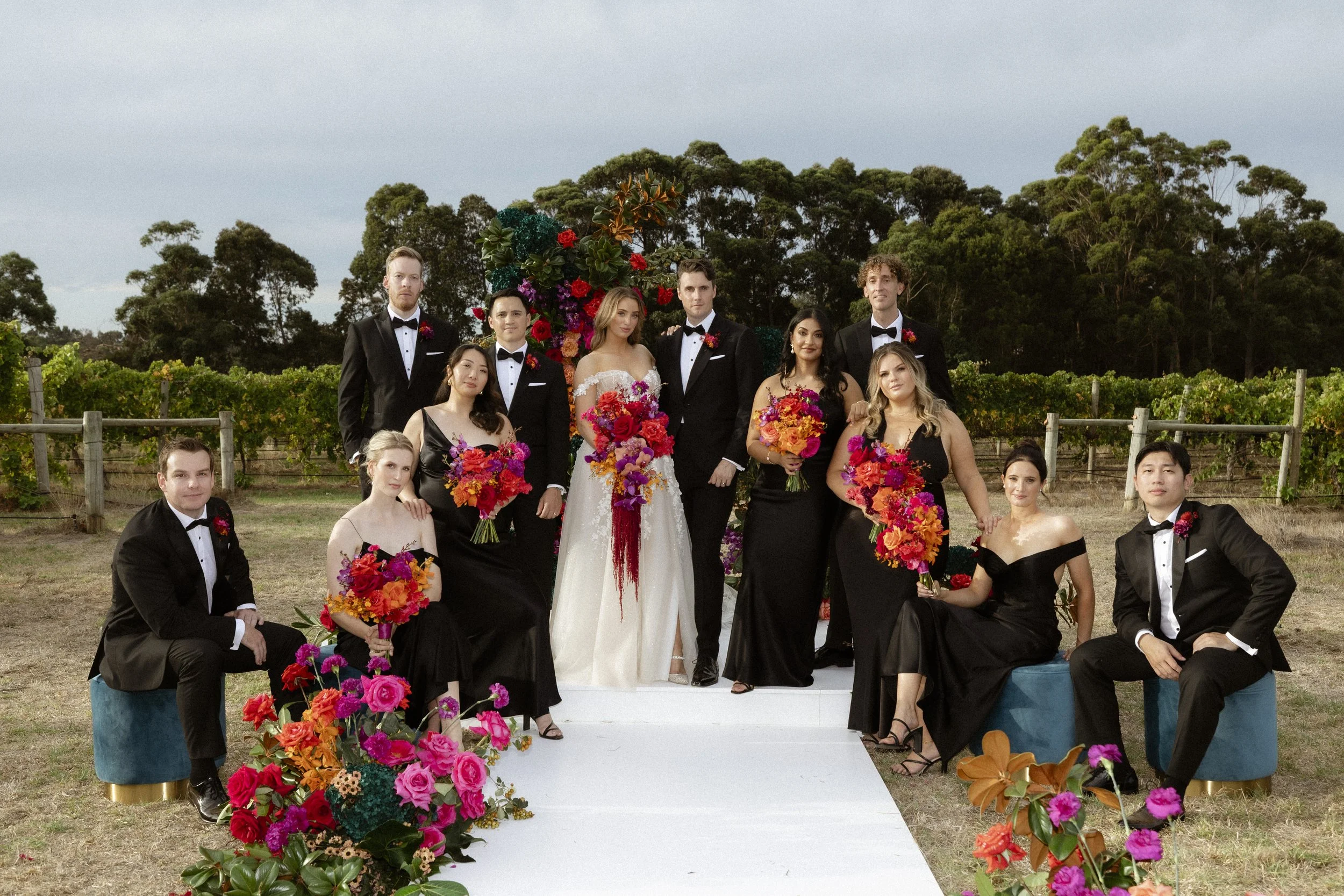 Bride, Groom and their wedding party posing post marriage cermeony among the vineyards at Cherubino Winery in Wilyabrup W.A