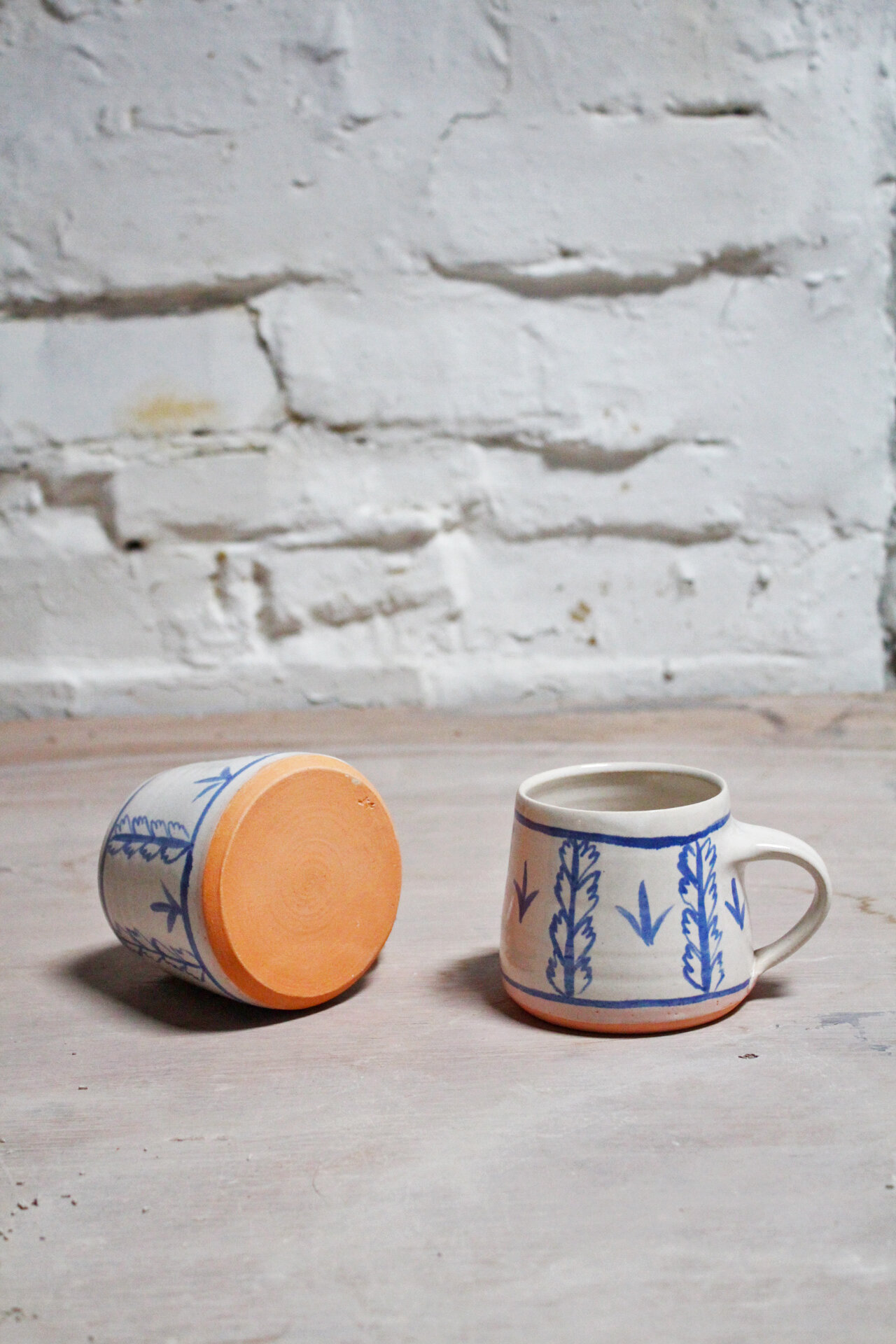 mug pair brushwork with orange bases portrait.jpg