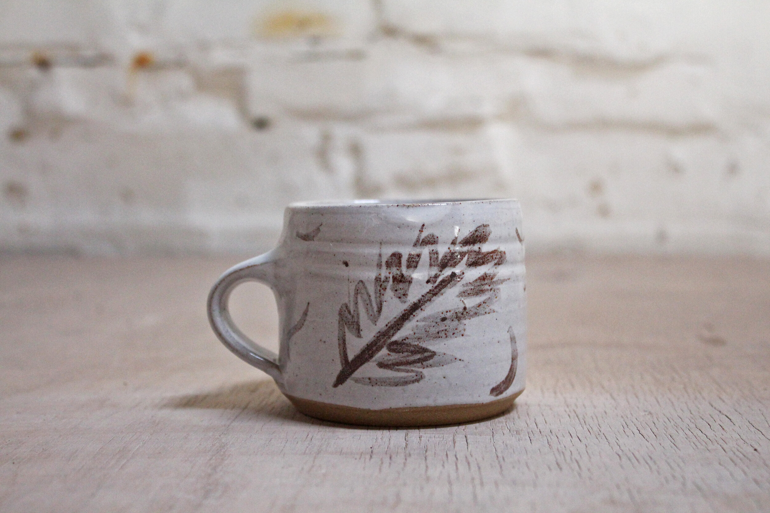 Iron Brushwork on a coffee cup landscape.jpg