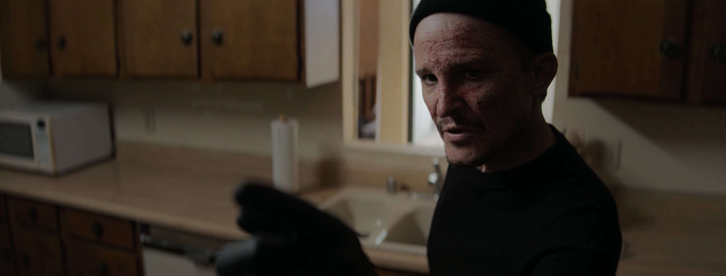 6. Damon Herriman as the hitman in DIY 2025.png
