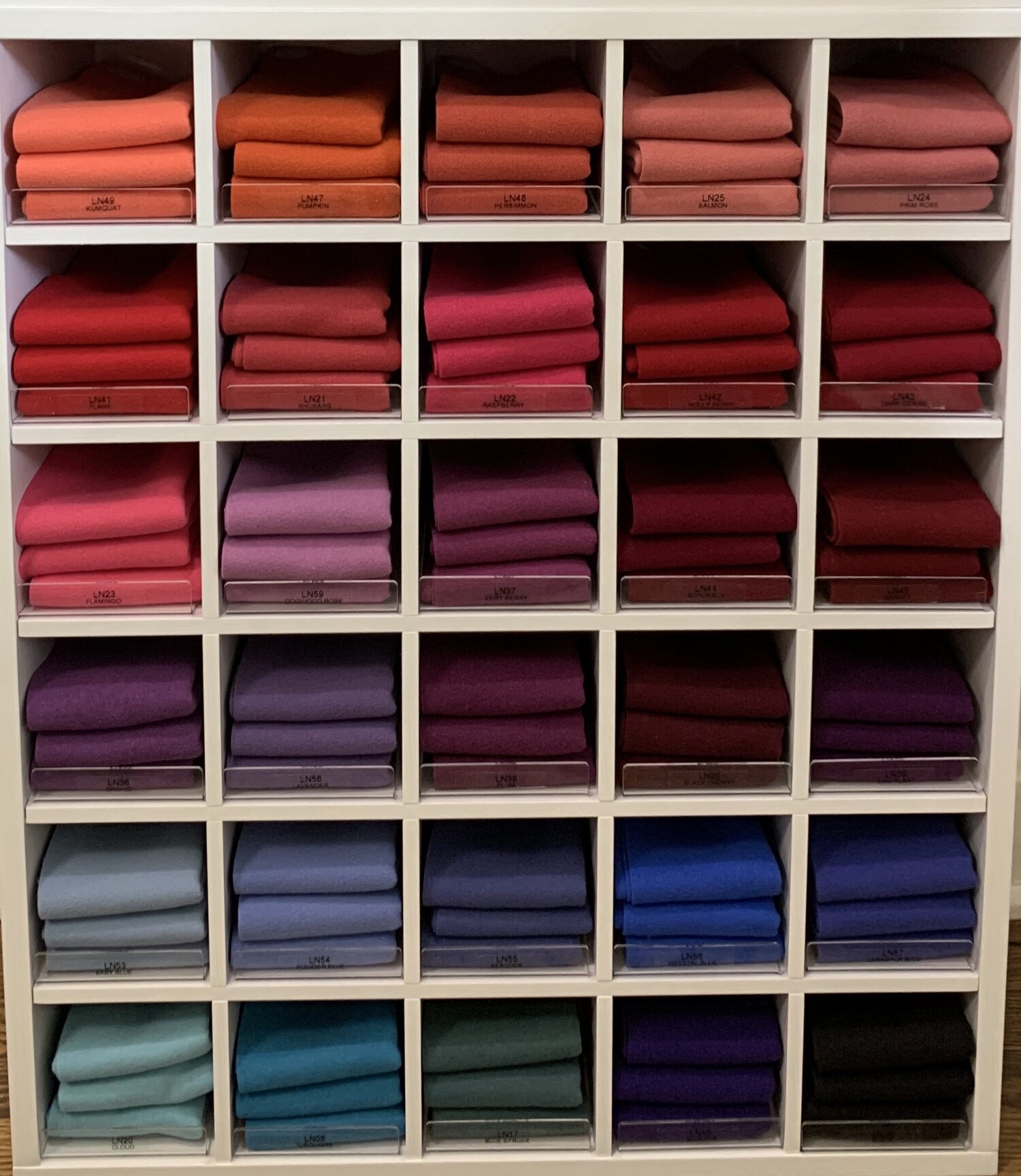 Premium Photo  Stack of wool cloth on shelf