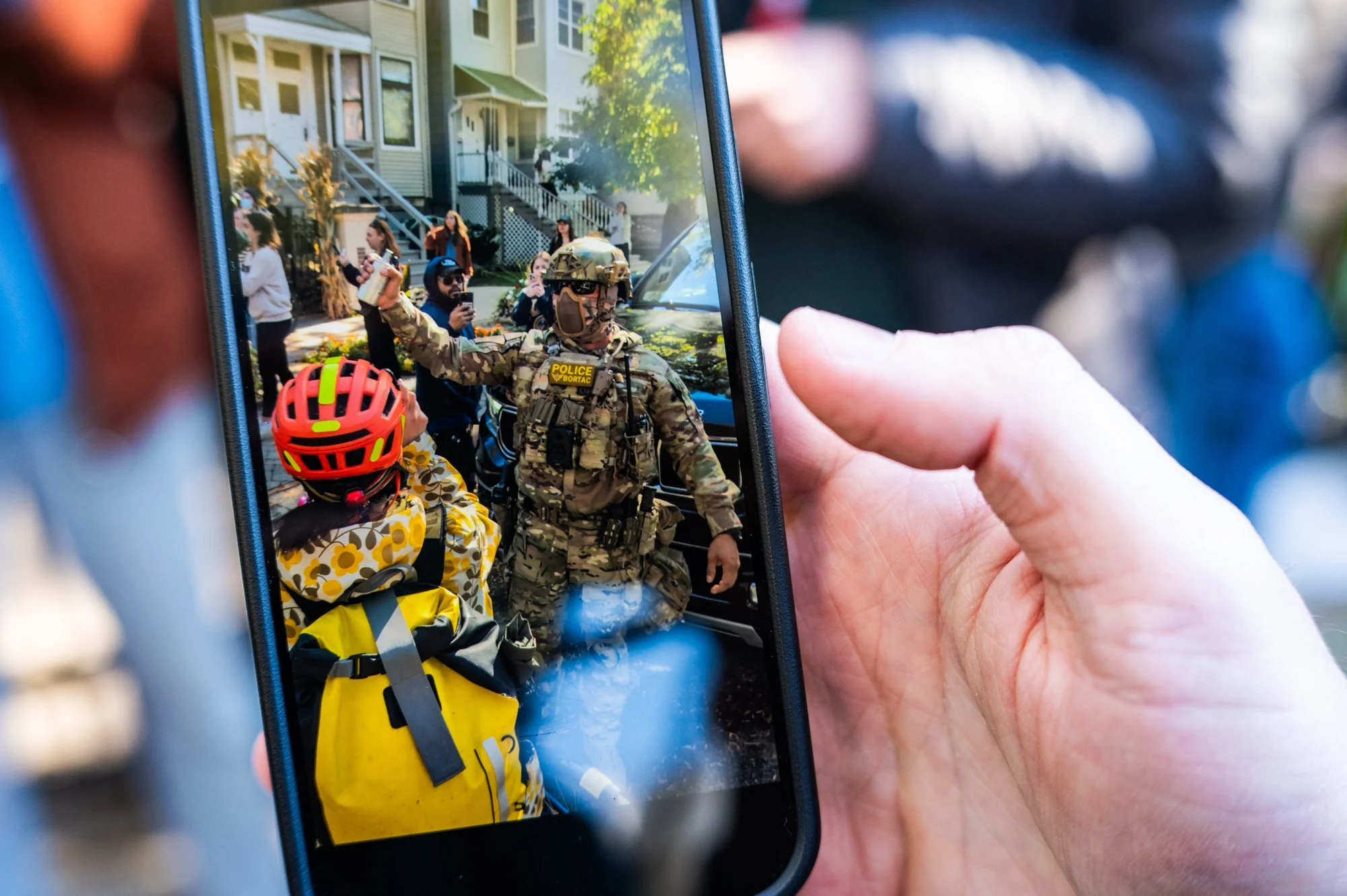  A federal agent holds up what appears to be a canister of chemical agent as federal agents detained a construction worker in the 3300 block of North Lakewood Avenue in Lakeview, and then threw chemical agents at responding neighbors on Oct. 24, 2025