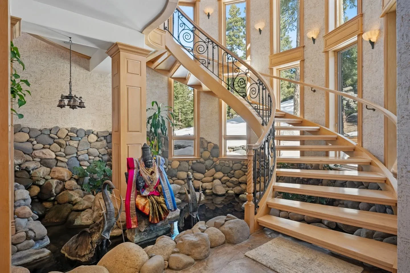 Part 1 of this exceptional estate tour ☀️

Beyond the hand carved Ganesha door, an indoor koi pond flows at the base of an awe-inducing spiral staircase (can you believe that hand-painted celestial dome?). The Grand Room lives up to its name, showcas