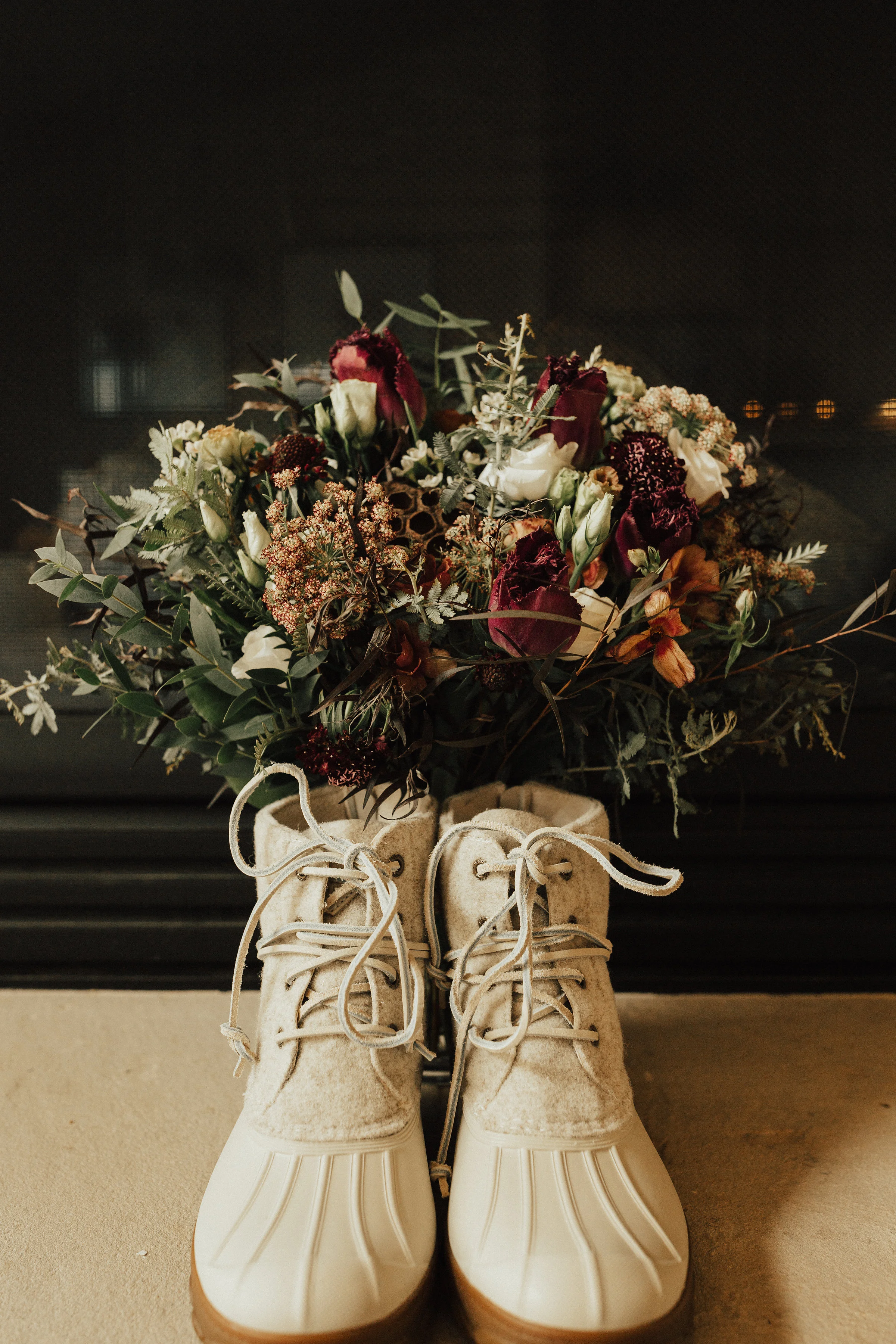 brides elopement rainboots holding custom elizabeth mckenzie fall floral arrangement.jpg