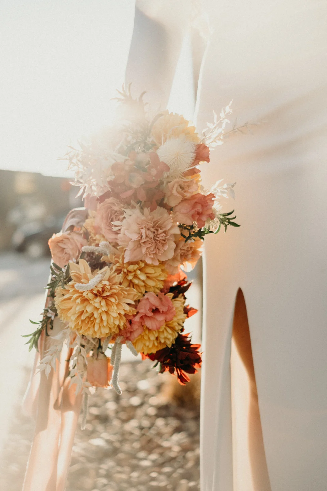 sun shining through bright yellow custom floral arrangement with bride for collaboration in kansas city.jpg