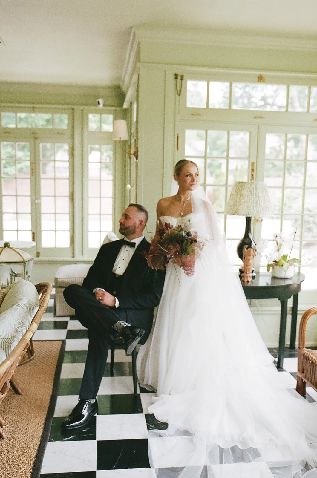 Bride and groom with a colorful wedding bouquet at The Truitt boutique hotel in Kansas City.