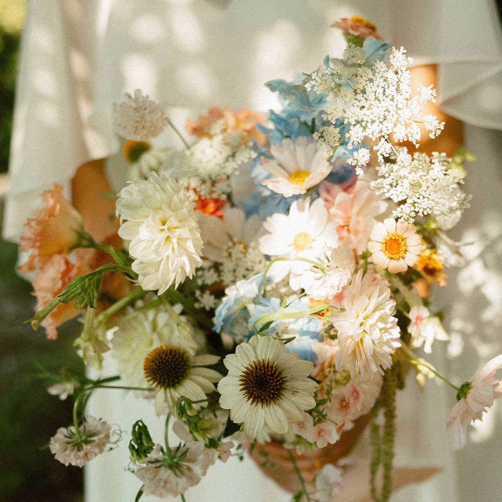Garden-inspired floral arrangement with hydrangeas, daisies and soft pastel flowers designed by Elizabeth McKenzie Florals.