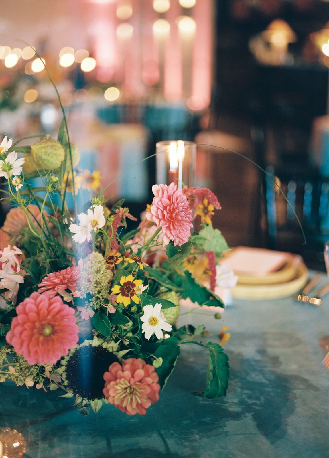 Colorful wedding centerpiece with pink, yellow and white florals at The Guild in Kansas City’s Crossroads Arts District.
