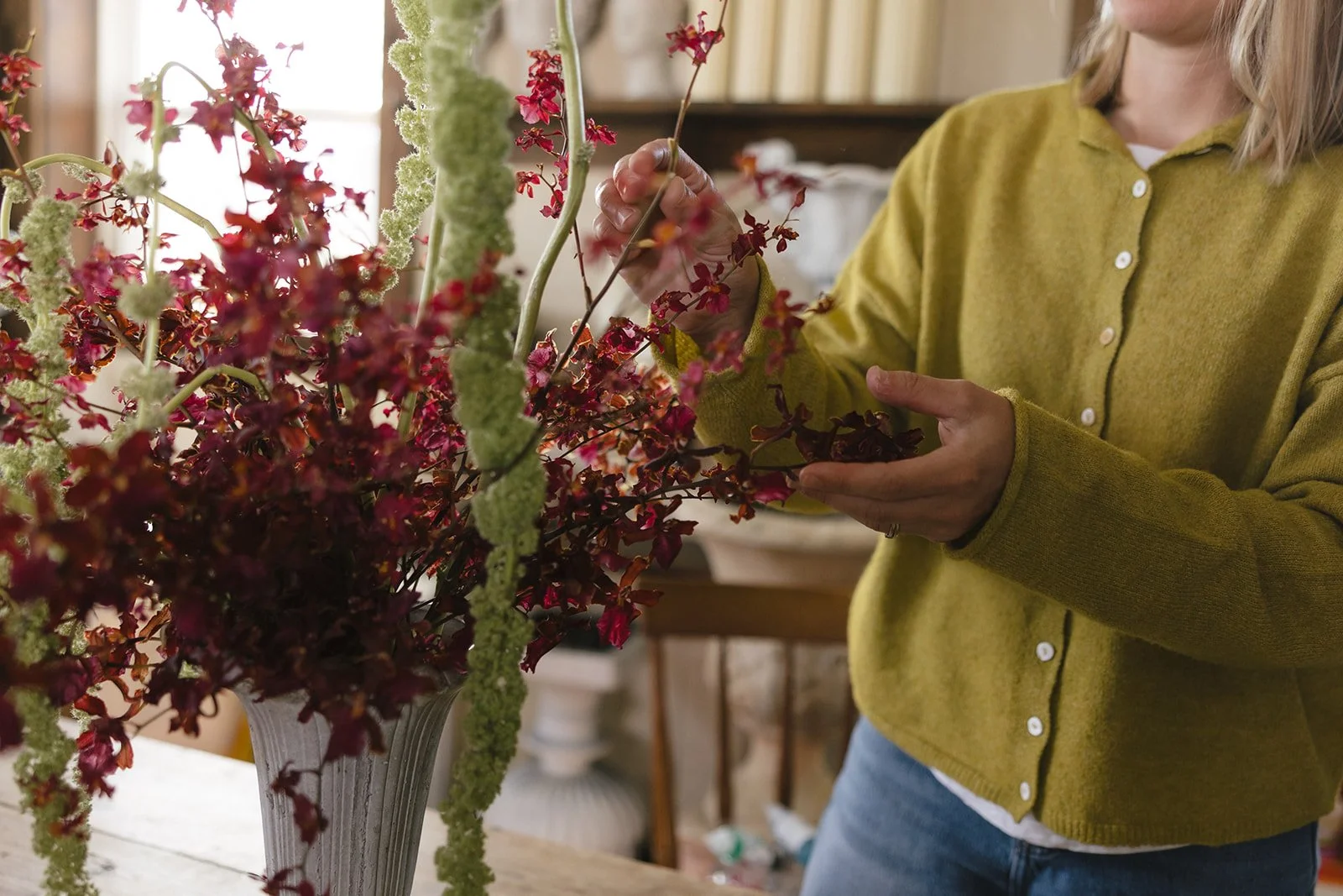 Saige arranging fresh flowers in the Elizabeth McKenzie Florals home studio in Kansas City.