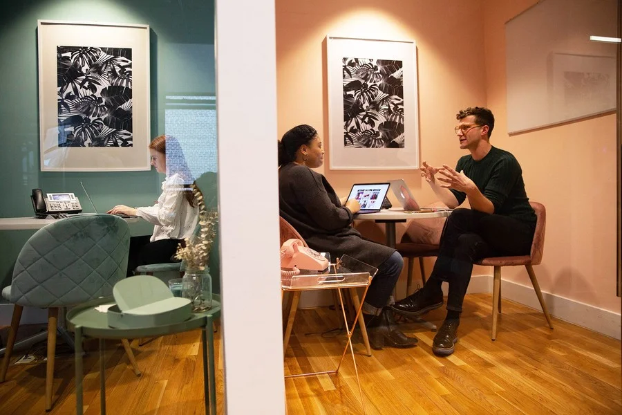 Two of Small Girls PR New York workspaces, beautifully color-coordinated, one seafoam green and the other a lovely peach.