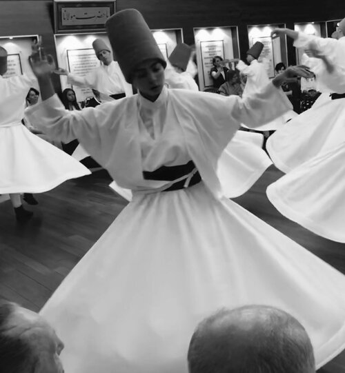 "Whirling Dervishes" are practitioners of the Sufi religion. They twirl around the room in precise choreographed circles as they meditate with the goal of reaching perfection. As they spin, the right hand faces up to receive the grace from God and t