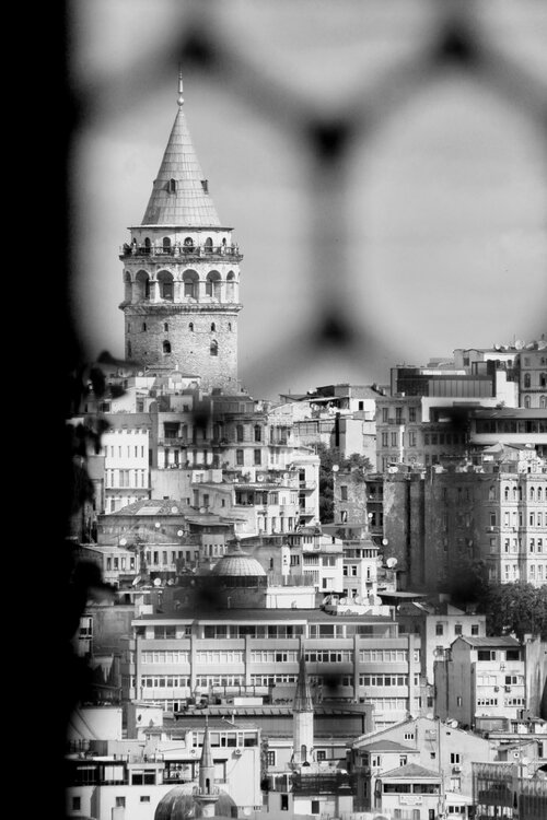 Galata Tower as viewed from the Topkapi Palace across the Golden Horn estuary. The tower is located in the Karaköy neighborhood of the Beyoğlu district, which is full of restaurants, shopping areas and has a very active nightlife scene.