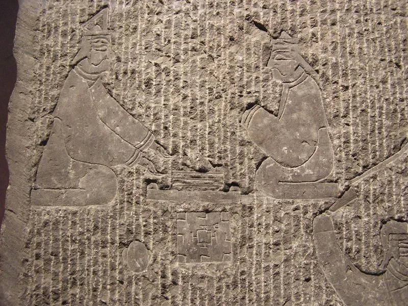 Carving of two men playing liubo