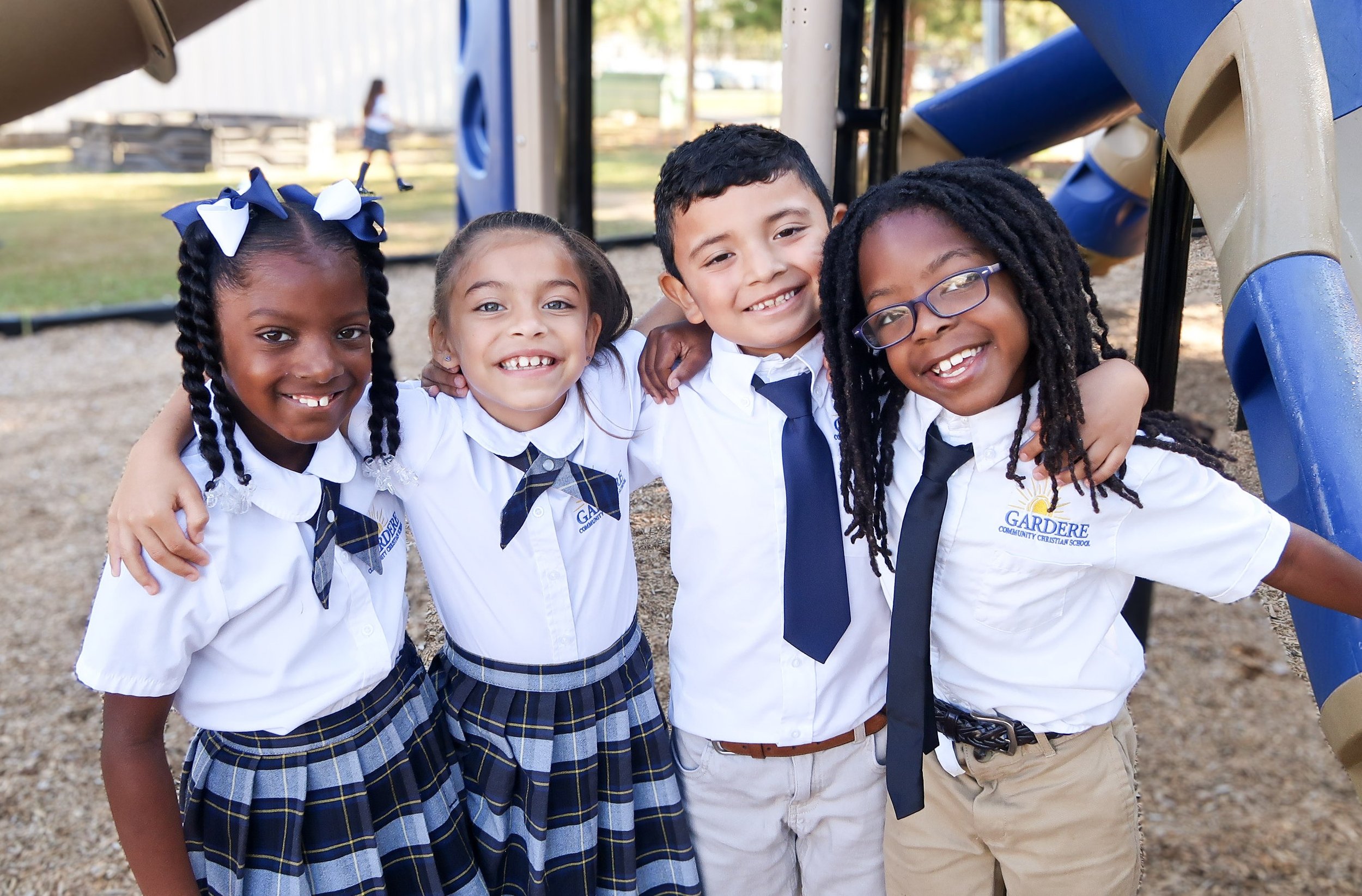 Happy children dressed in clean, crisp school uniforms. Gardere, School culture, respect, private school, scholarships