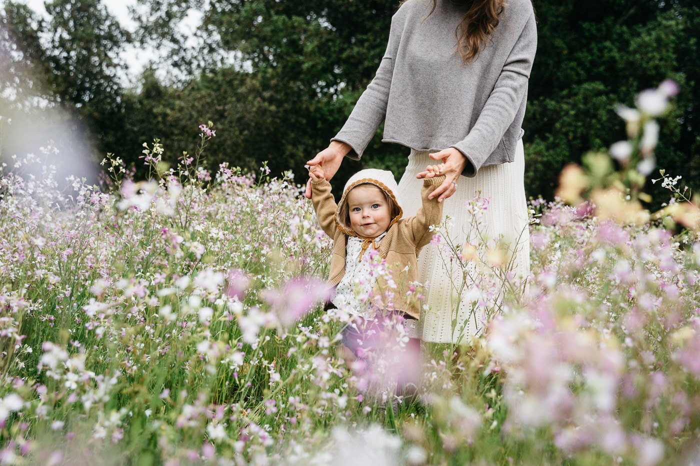family with toddler girl in field of wildflowers by Allison Busc
